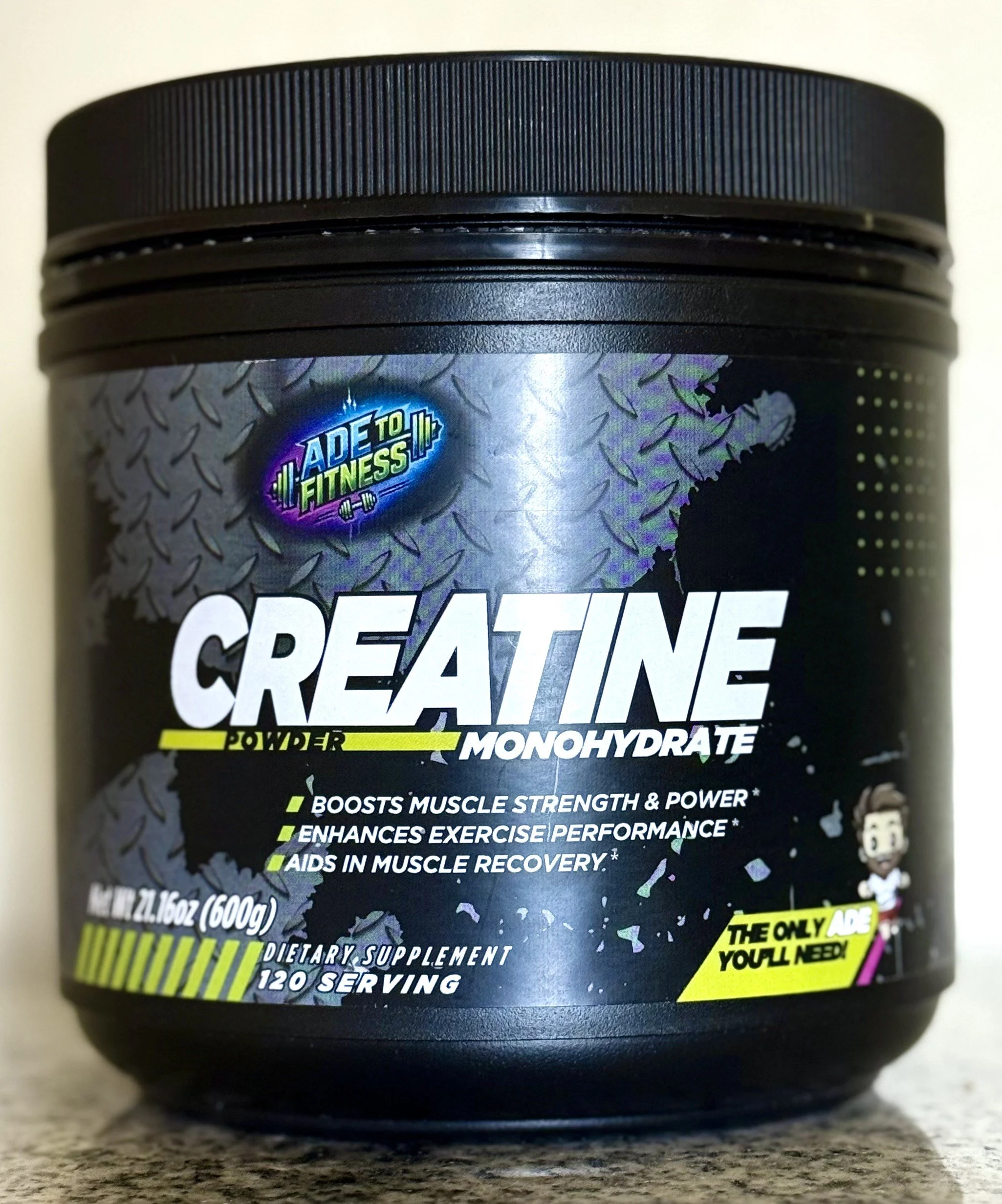 Container of Ade to Fitness Creatine Monohydrate powder with label details, including benefits like boosting muscle strength and aiding recovery.