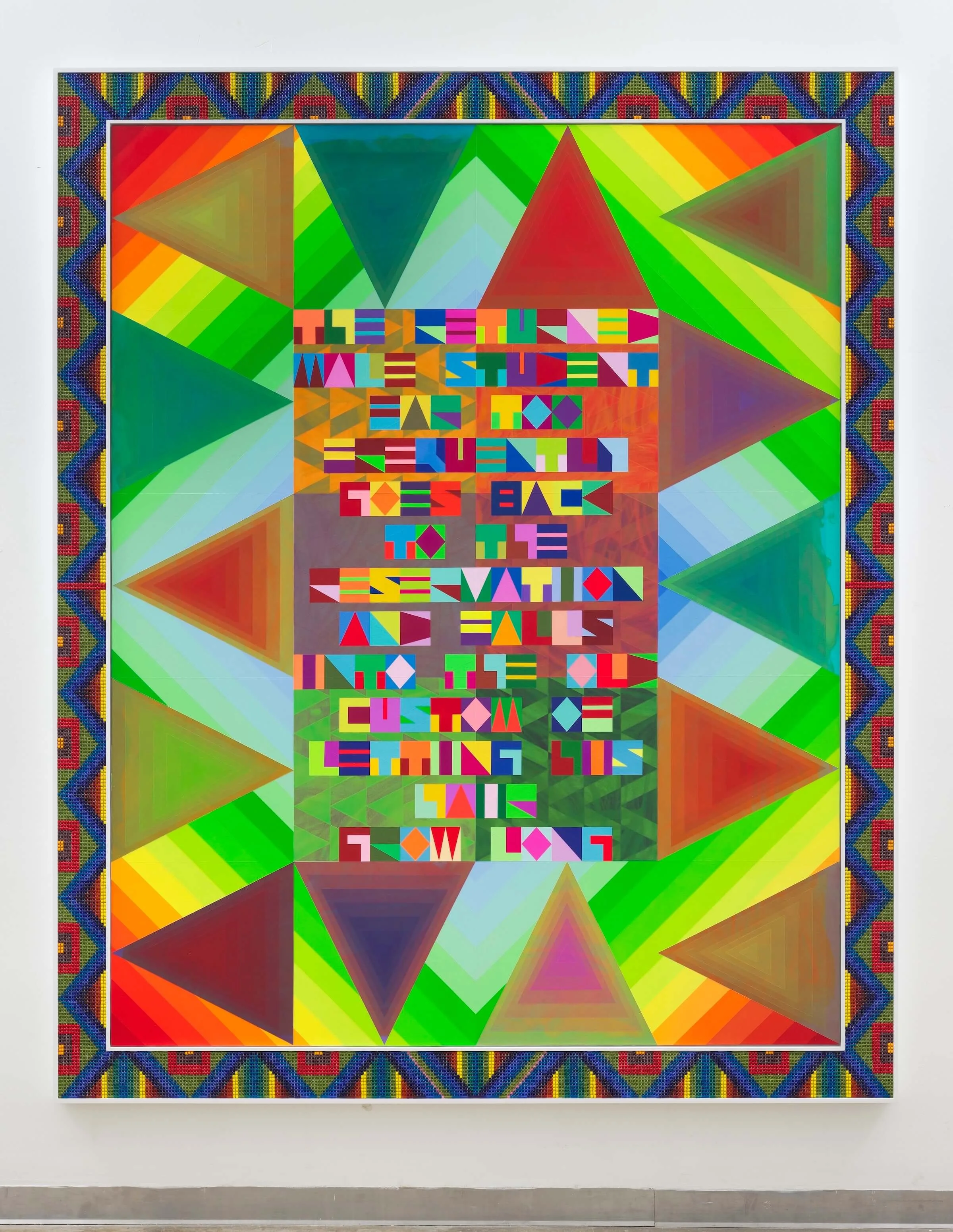Bright colored geometric artwork with beads and words in the middle