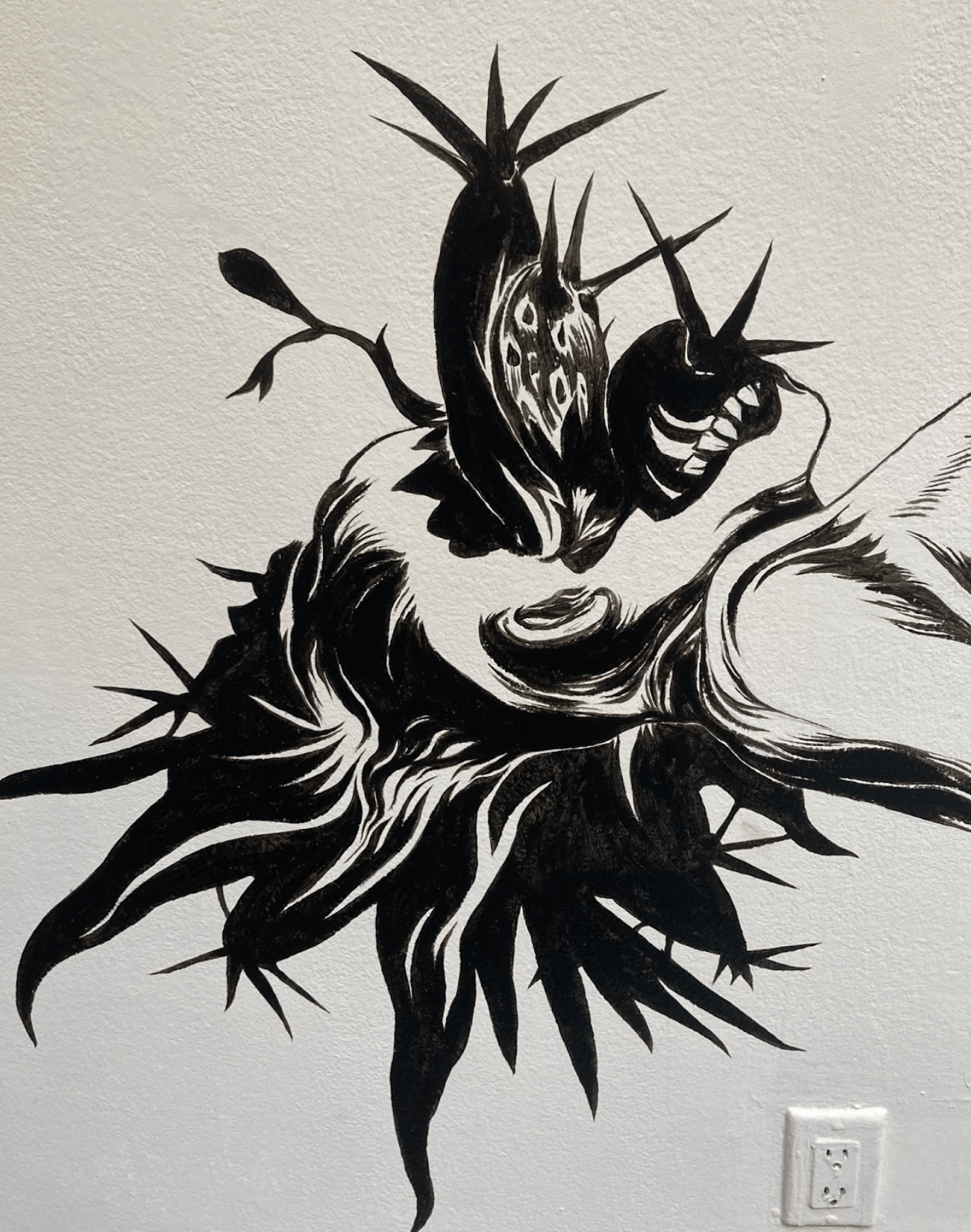 Osvaldo Ramirez Castillo Nahual , 2025, site-specific mural, black acrylic paint, 20 x 7.5 feet Detail image taken by the writer