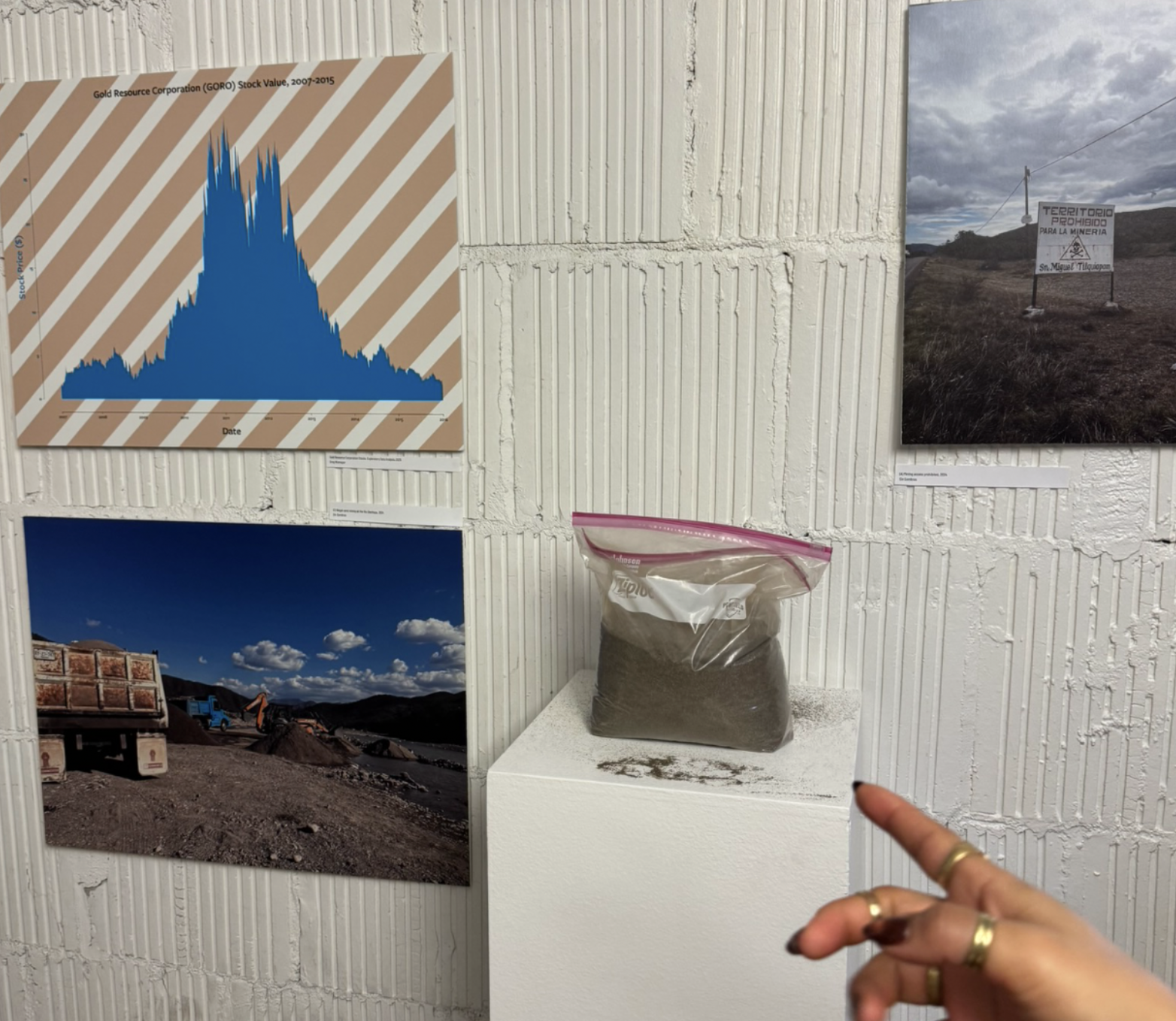 Graph of Gold Resource Corporation stock value over the years alongside sand sample 