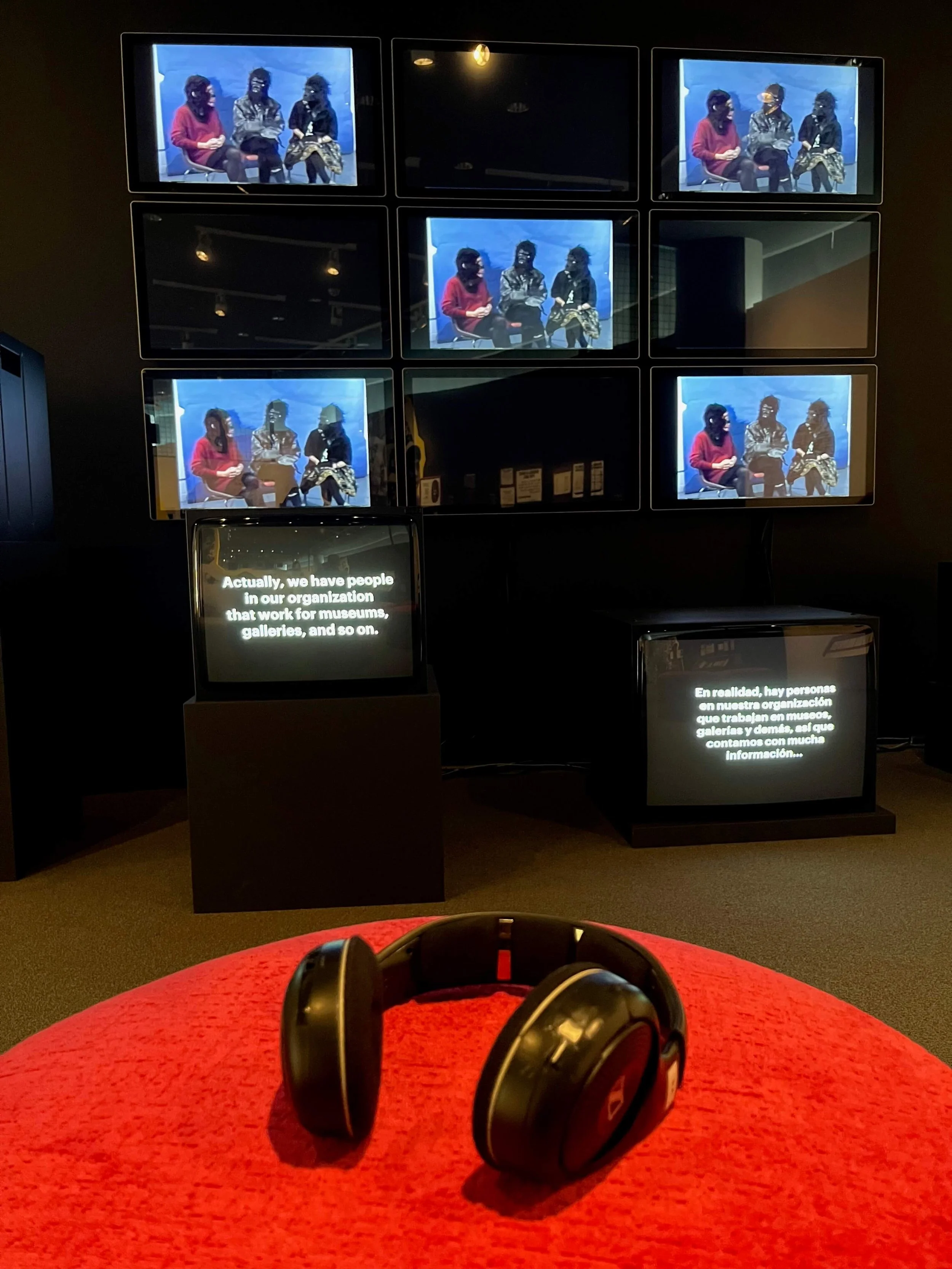 An area of the show with seats and headphones where visitors could watch and listen to Guerrilla Girls interviews.