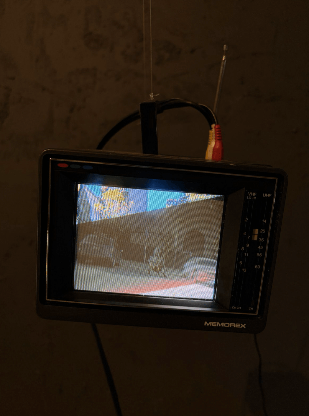 Detail. Suspended Memorex portable television playing video near the gallery entrance.