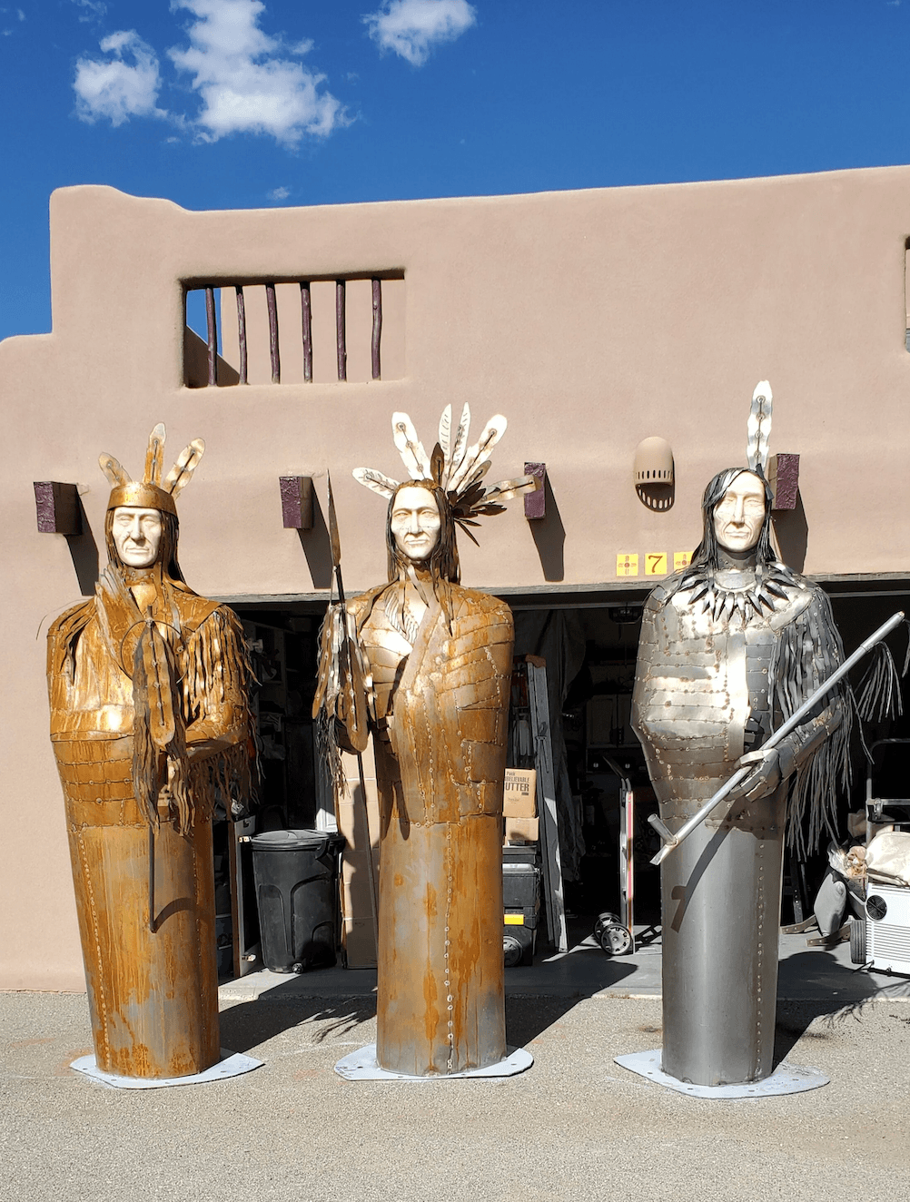   “SON OF THE STAR”, “FOUR BEARS” AND “TWO RAVENS”, Arikara, Mandan and Hidatsa Chiefs.  Each sculpture measures 9 feet tall and is welded corten steel with stone carved faces. Artist: Kathy Elkwoman Whitman, 2020. Image courtesy of the artist 