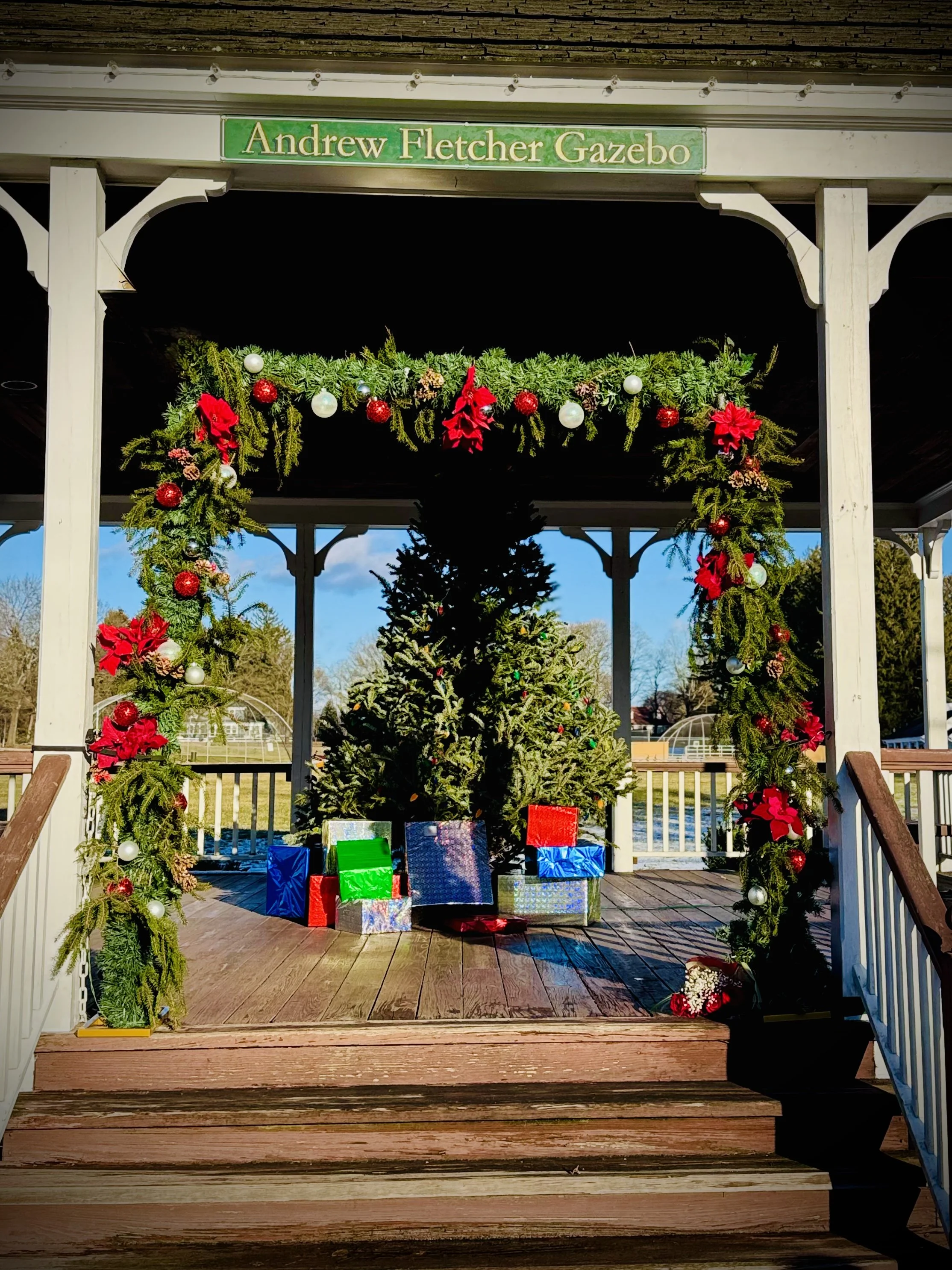Evergreen and poinsettia flower arch for an engagement proposal in NJ