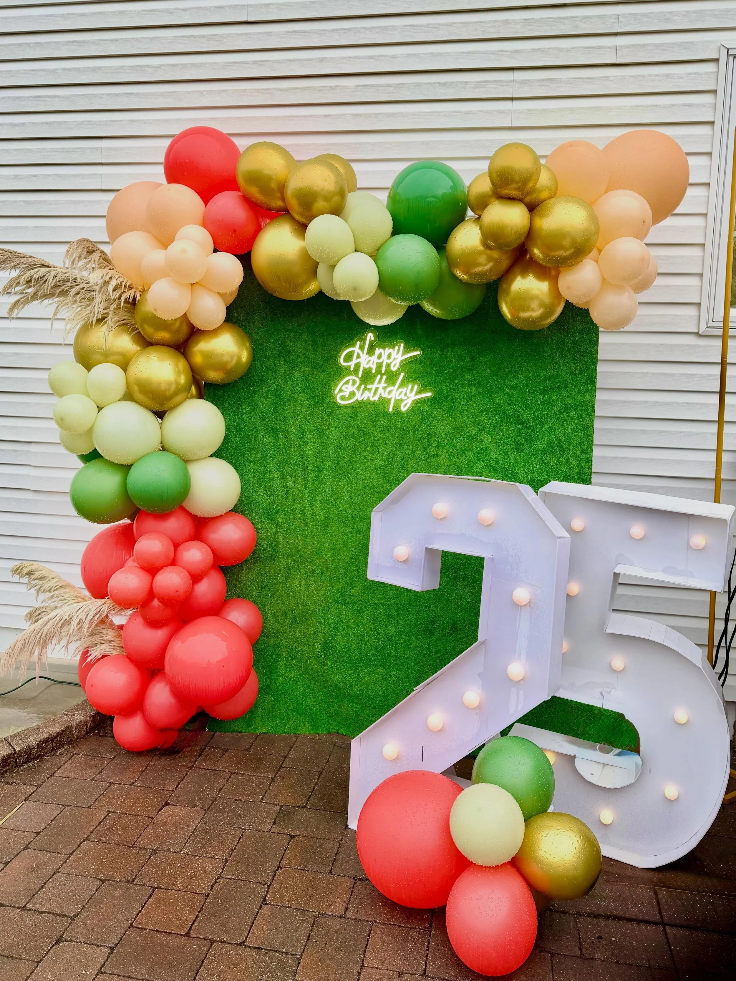 25 never looked so good ✨🎈

Loved creating this custom birthday backdrop featuring a luxe balloon garland, marquee numbers, pampas accents, and a vibrant grass wall for the perfect photo moment 🌿💚 The mix of coral, blush, sage, and metallic gold b