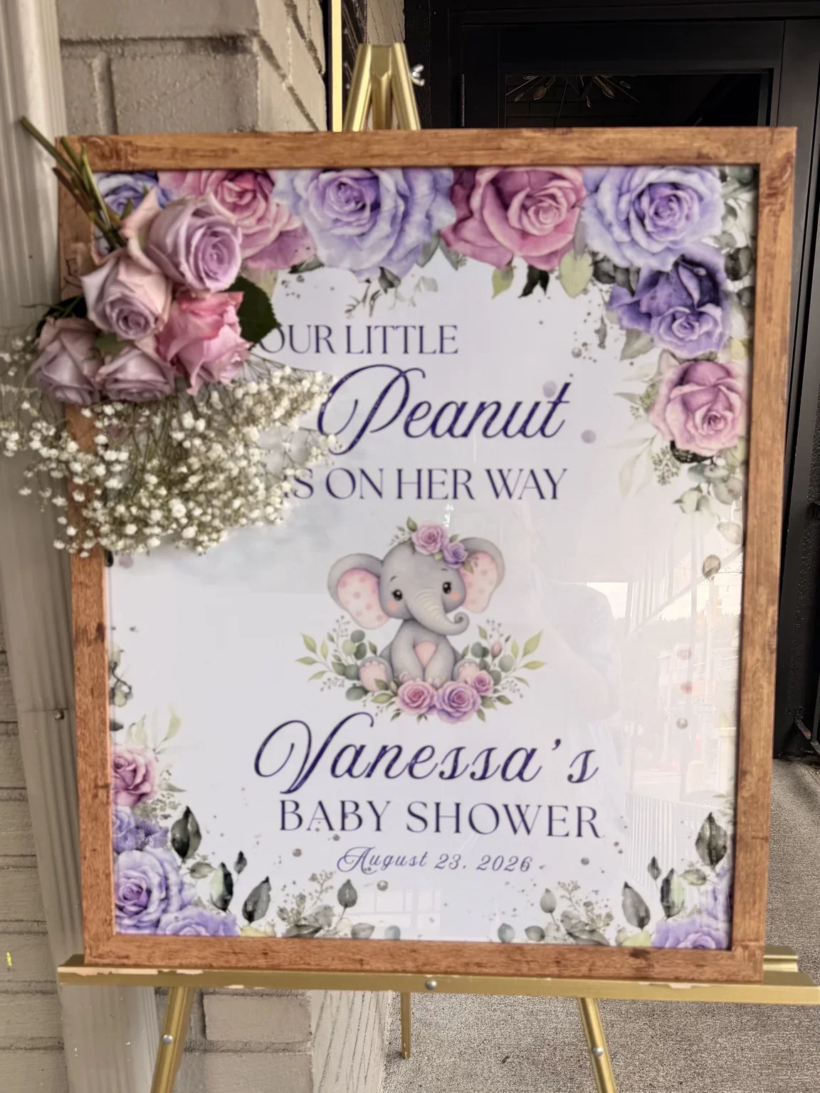 Baby Shower welcome sign on an easel with flowers