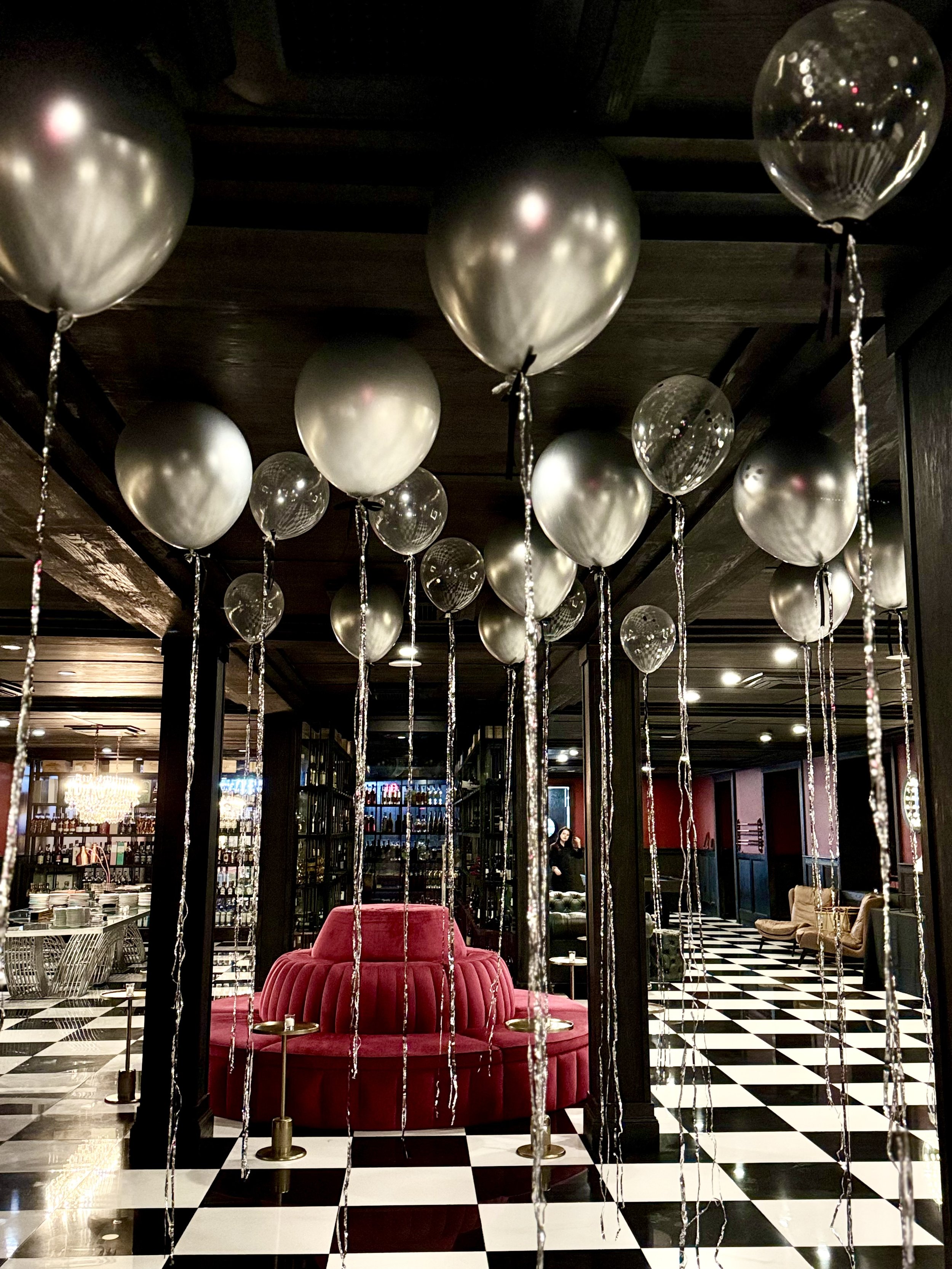 Balloons with tinsel and black bows At the summit hotel party