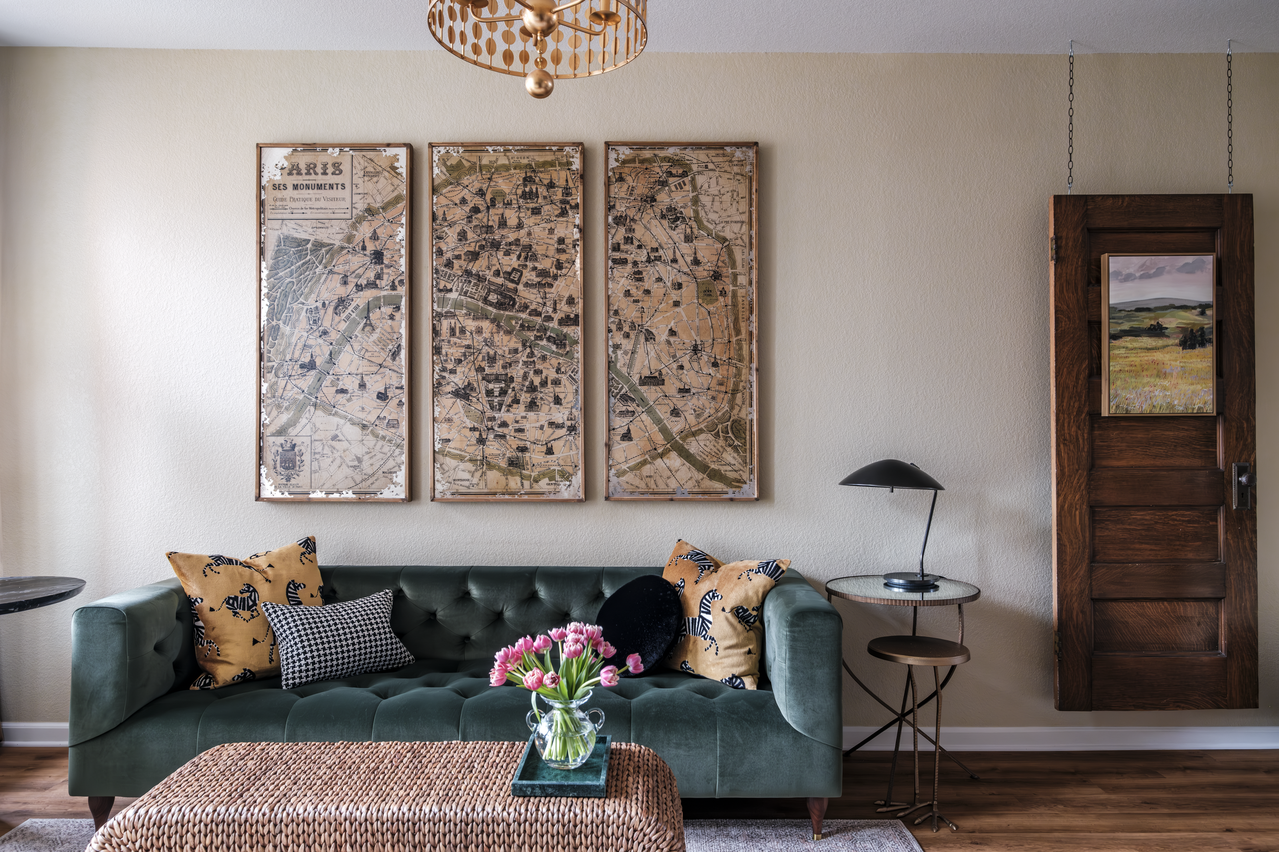 The 115 year old door serves as a unique backdrop for art while providing balance to the oversized antique map of Paris over the sofa. The mixing of furniture styles and layers of texture are the secret recipe for what makes this space so Parisian ec