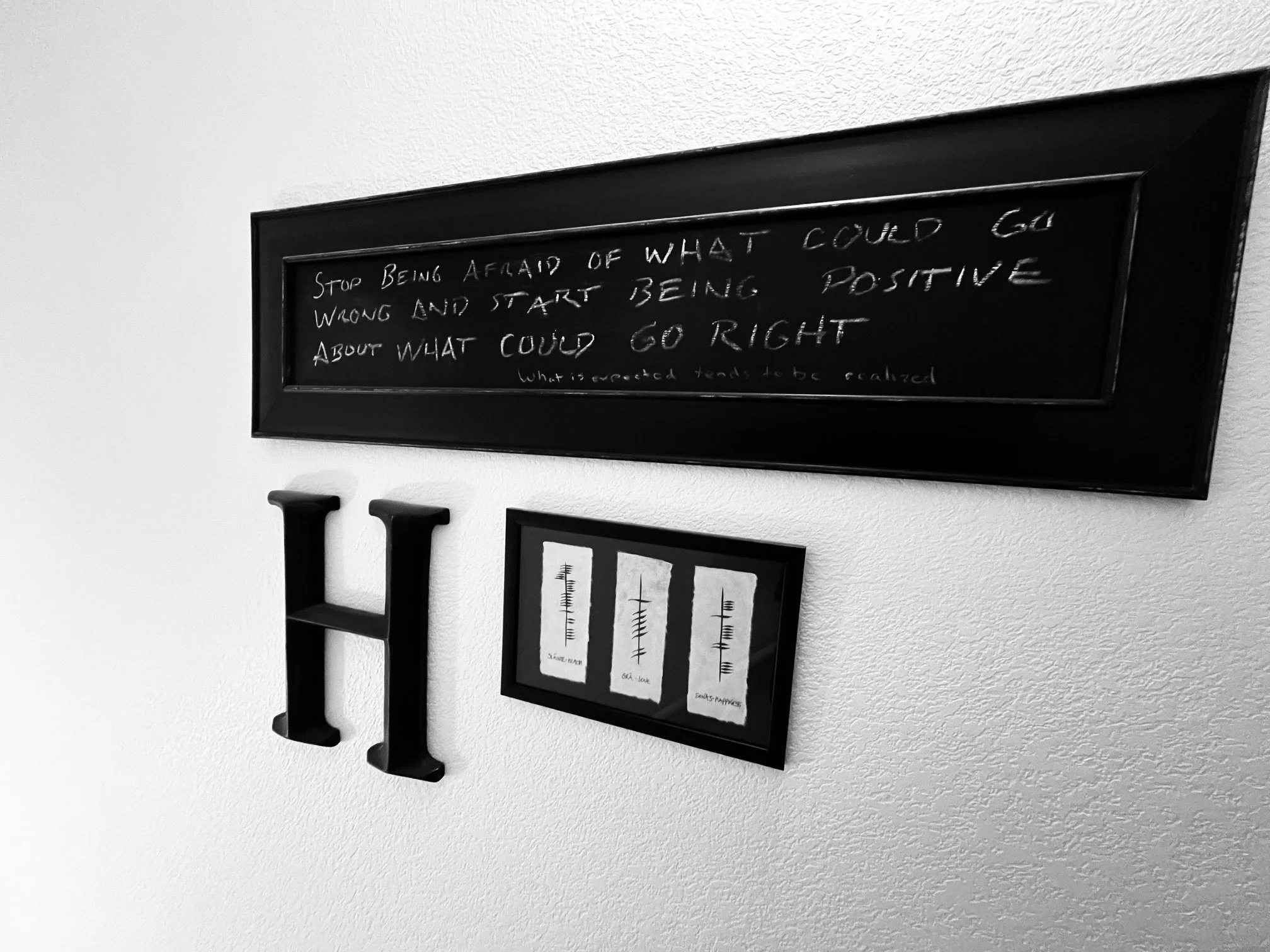 Letter H on wall with other decor.