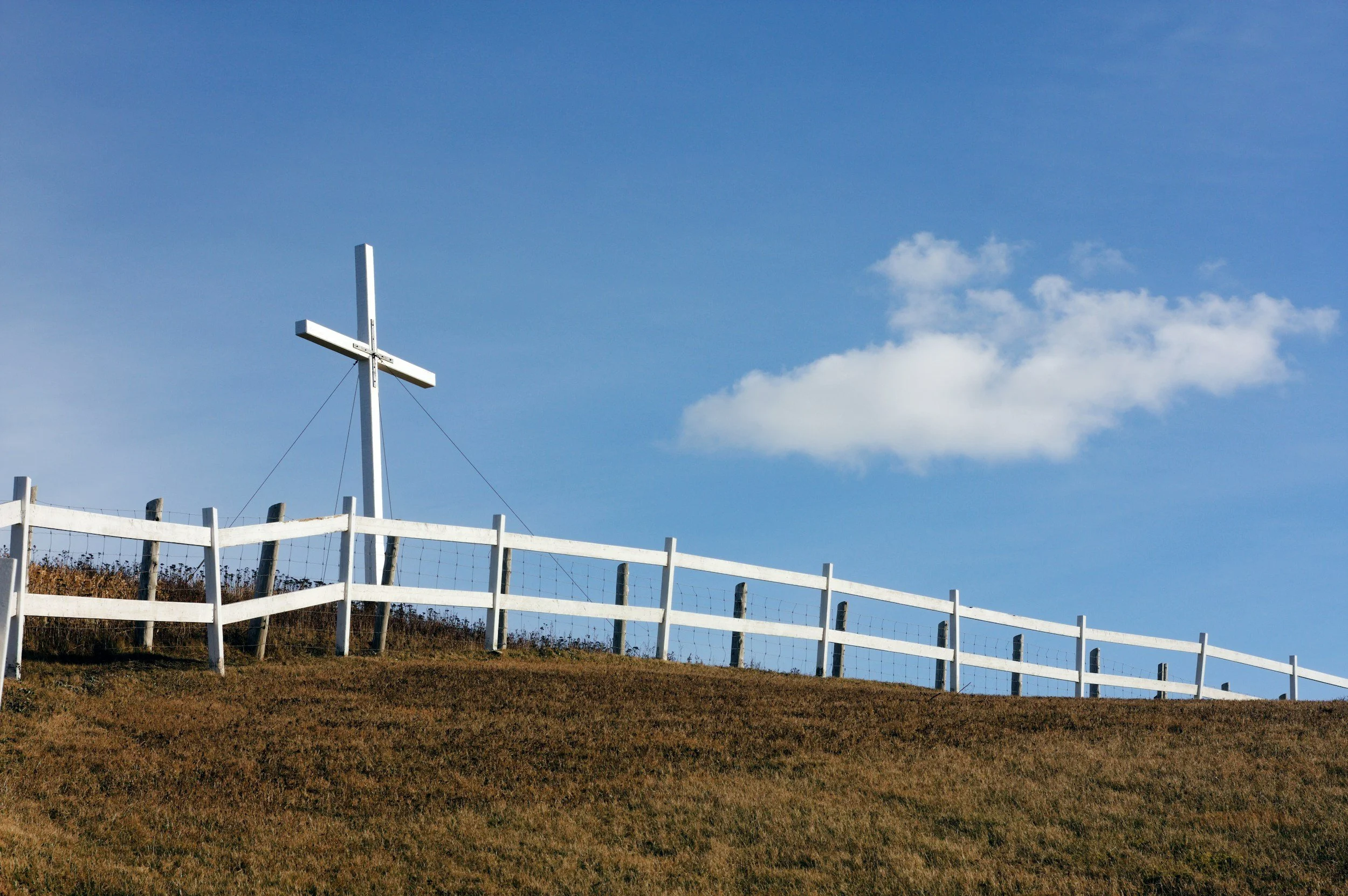 Wooden fence with a cross, symbolizing faith, healthy boundaries, and Christian counseling for relationships and personal growth.