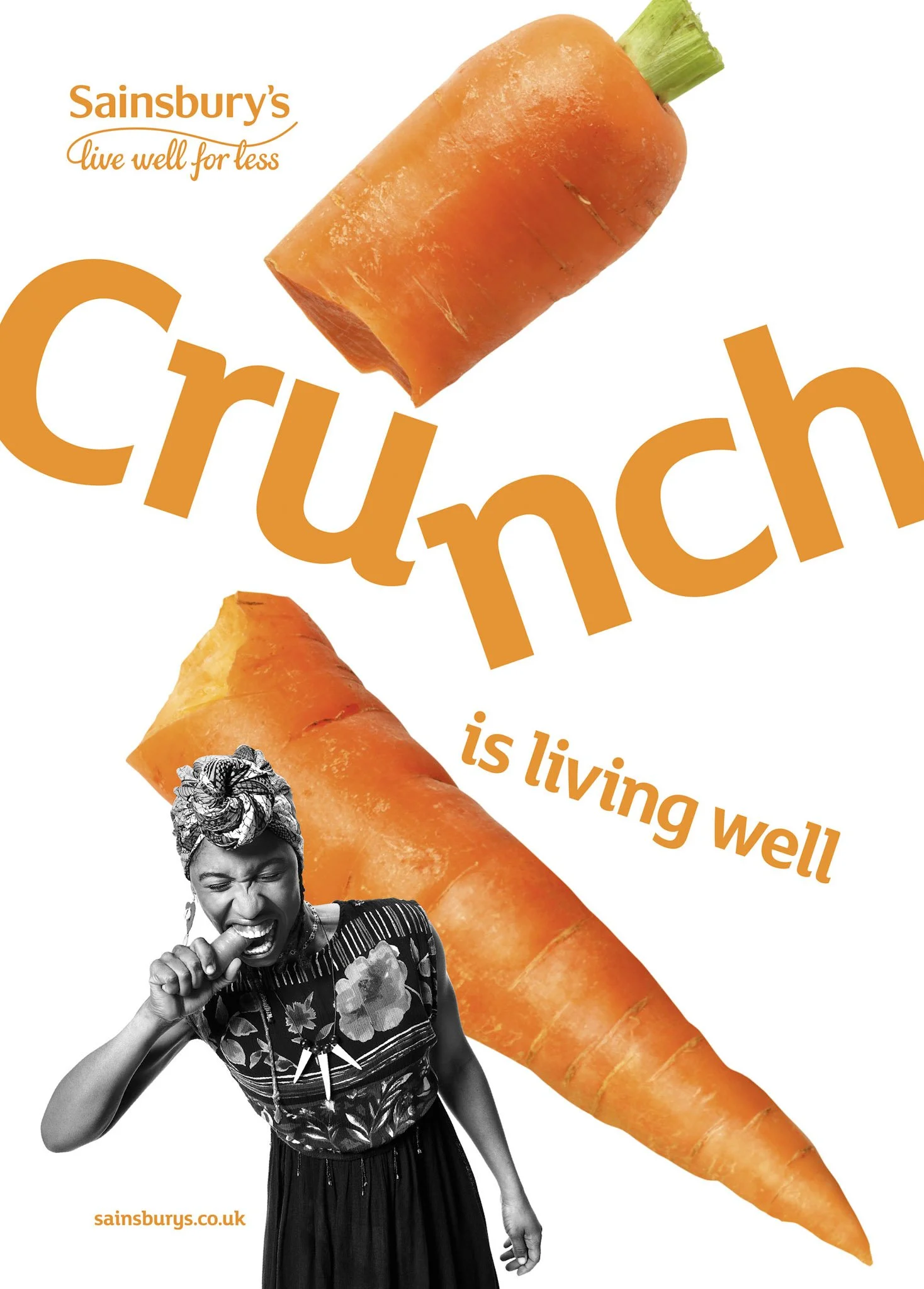A digital advertisement featuring a large carrot with broccoli stem, a black and white photo of a joyful woman eating a carrot, and text that reads 'Sainsbury's live well for less Crunch is living well' with the website sainsburys.co.uk.