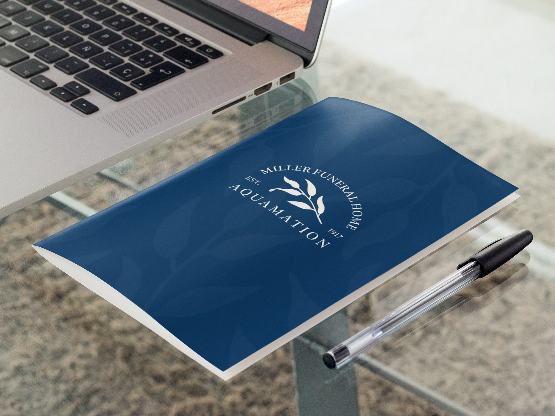 bifold-brochure-mockup-lying-next-to-a-laptop-in-an-office-a10308-2.png