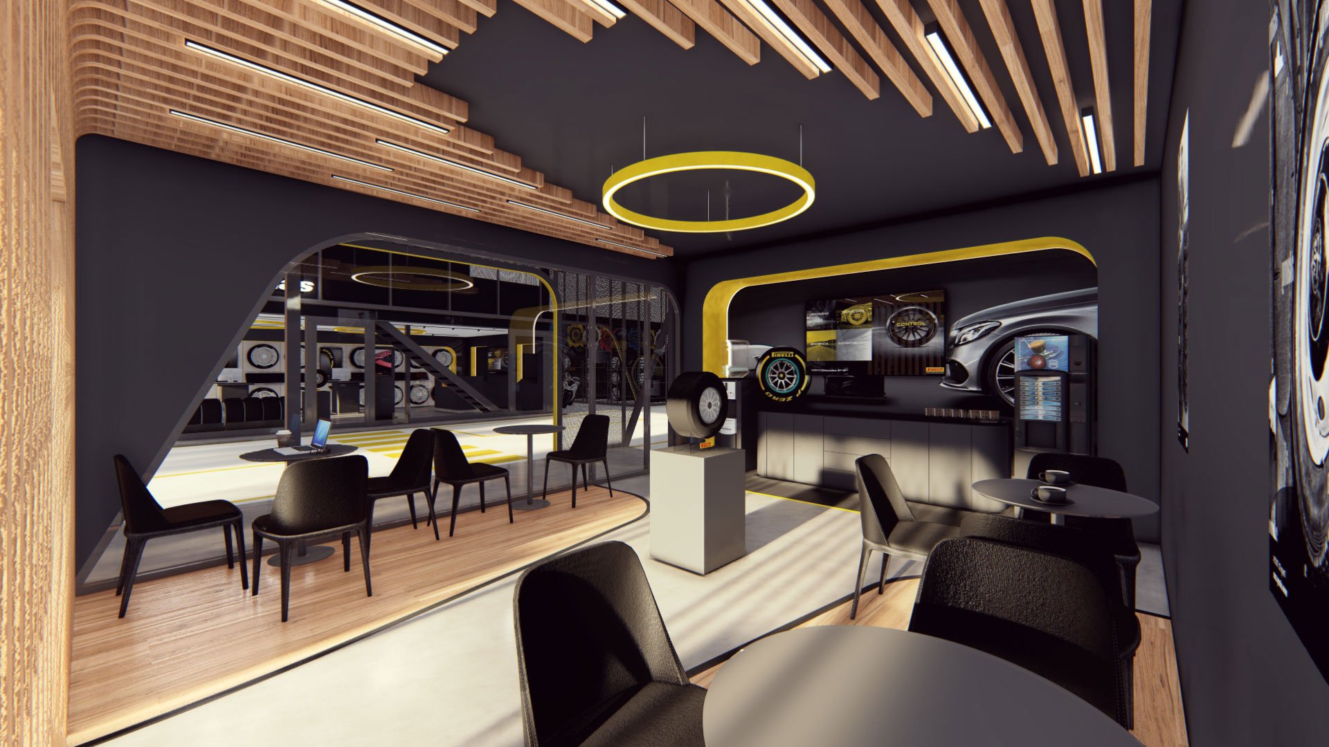 Interior de una sala de exhibición de autos con decoraciones en negro y amarillo, mesas y sillas negras, y un área de atención con una maquinaria para neumáticos.