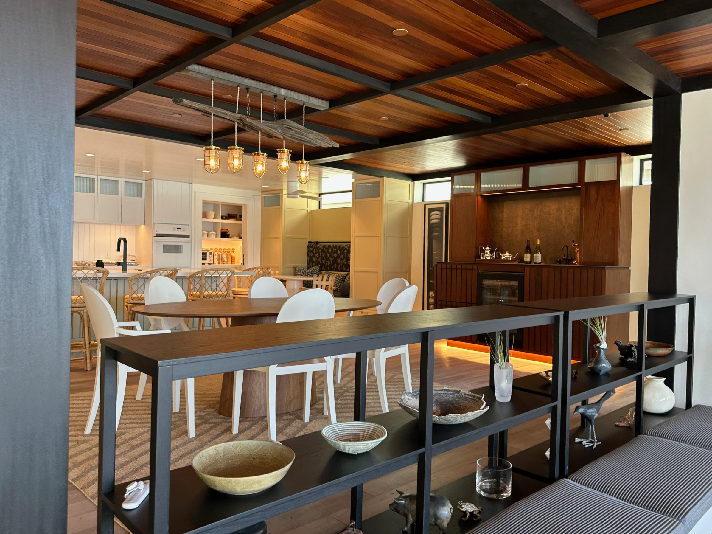 Artisanal Kitchen and dining area of luxurious Bel Marin home with custom cabinetry, panelling, and trim in African Mahogany refinished by the excellent Bay Area painting company Chroma Colors.