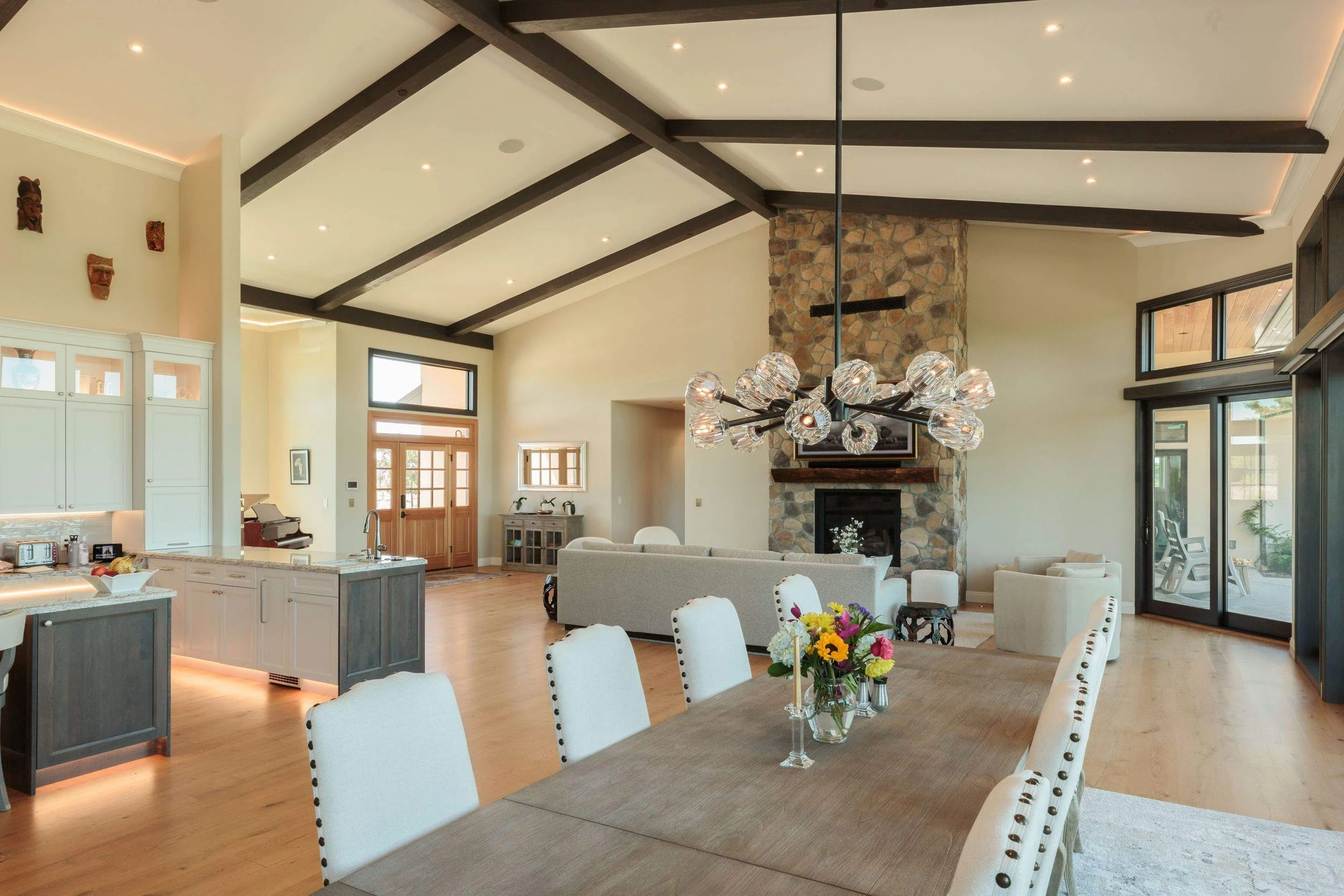 Great room and dining area of luxurious new construction Napa home with custom cabinetry and painting finished by Bay Area luxury painting company Chroma Colors.