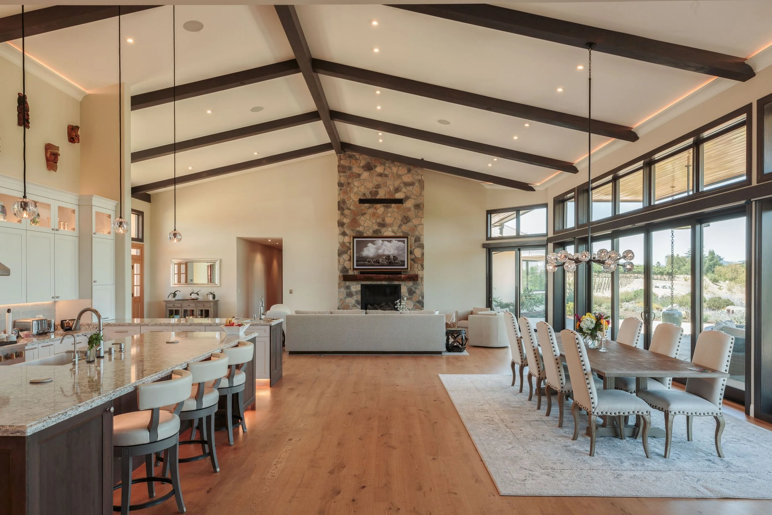 Great room and dining area of luxurious new construction Napa home with custom cabinetry and painting finished by Bay Area luxury painting company Chroma Colors.