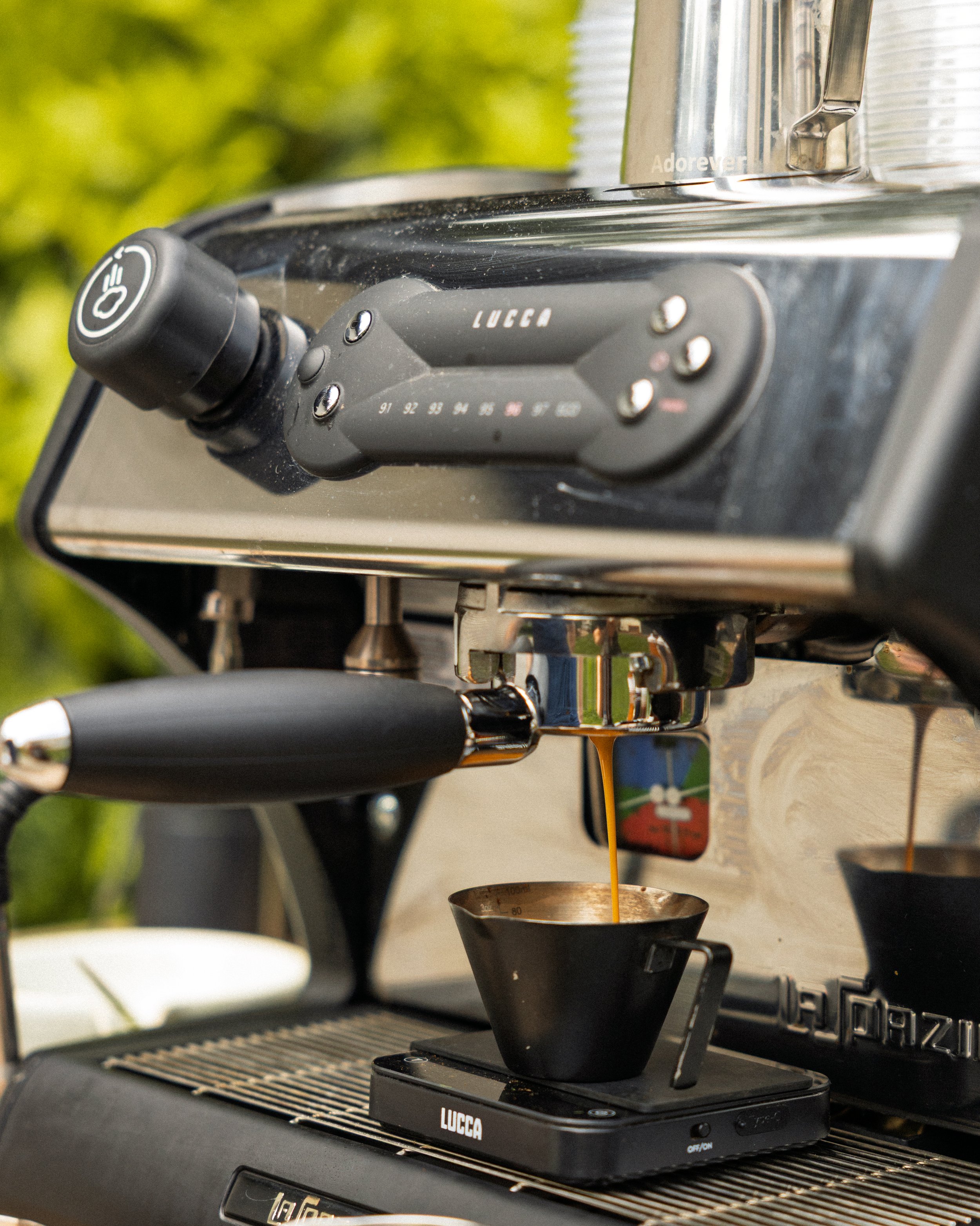 A shot of espresso is being pulled for an outdoor event