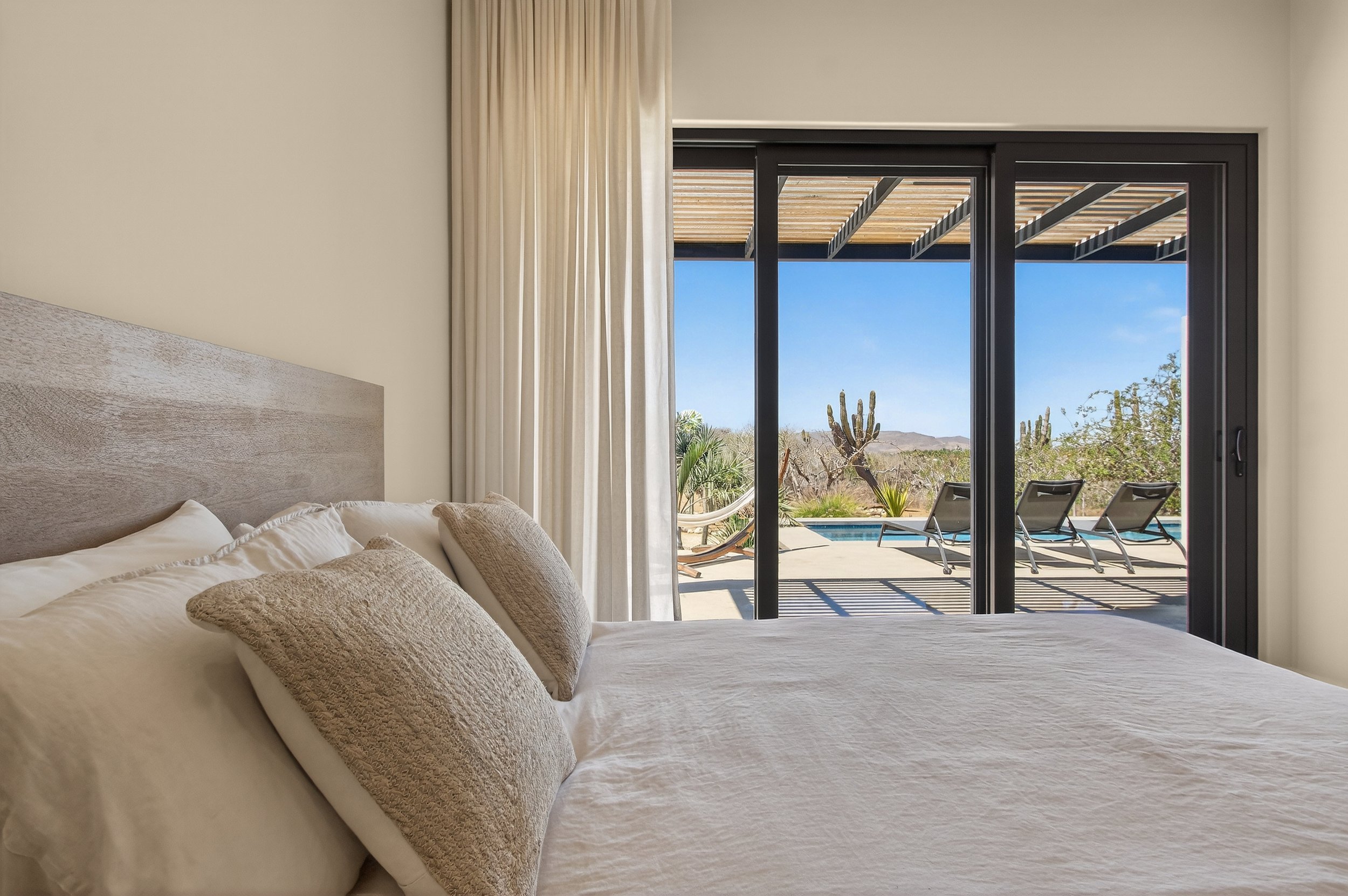 Serene bedroom at Villa Pacifica with pool views in Pescadero Baja