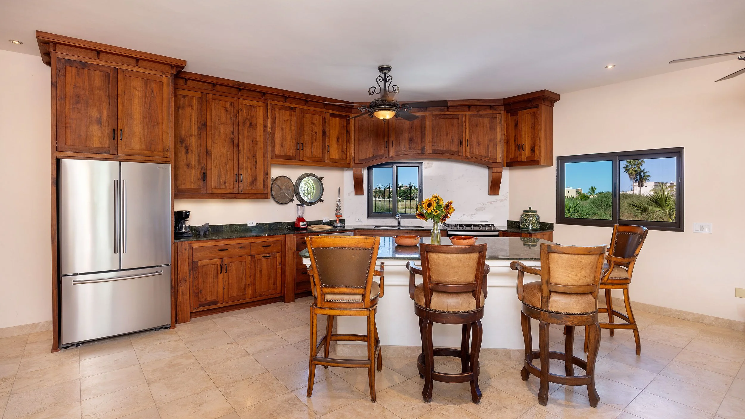 Kitchen in Villa 1 with custom black walnut cabinetry in a Pescadero beach home.