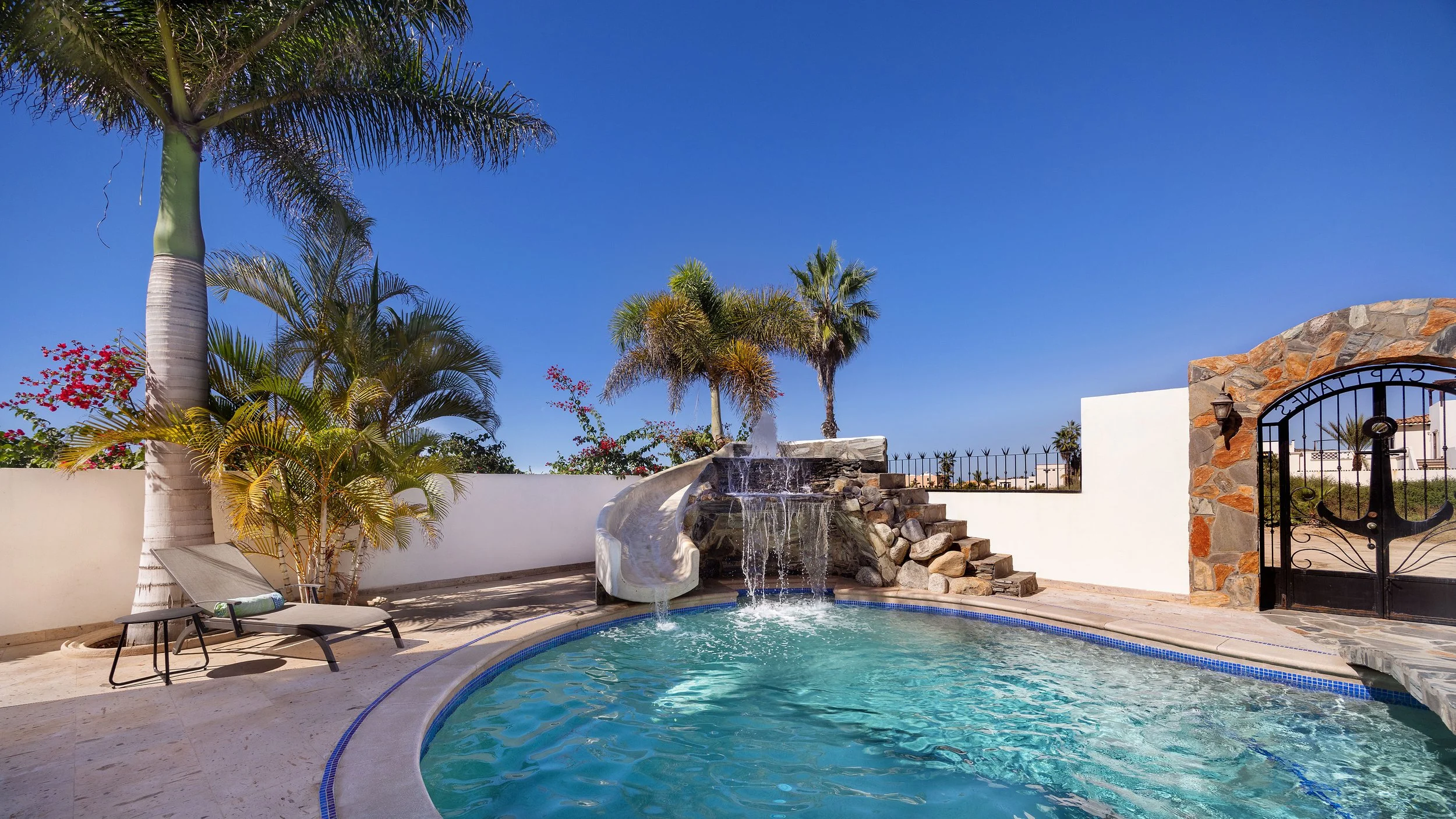 Resort-style pool with waterfall at a private beachside compound in Pescadero.