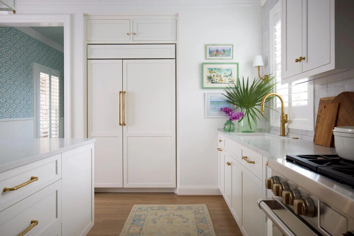 Elizabeth Hartz interior designer Virginia Beach kitchen with white cabinetry, brass hardware, marble countertops, and soft coastal accents in a refined oceanfront home