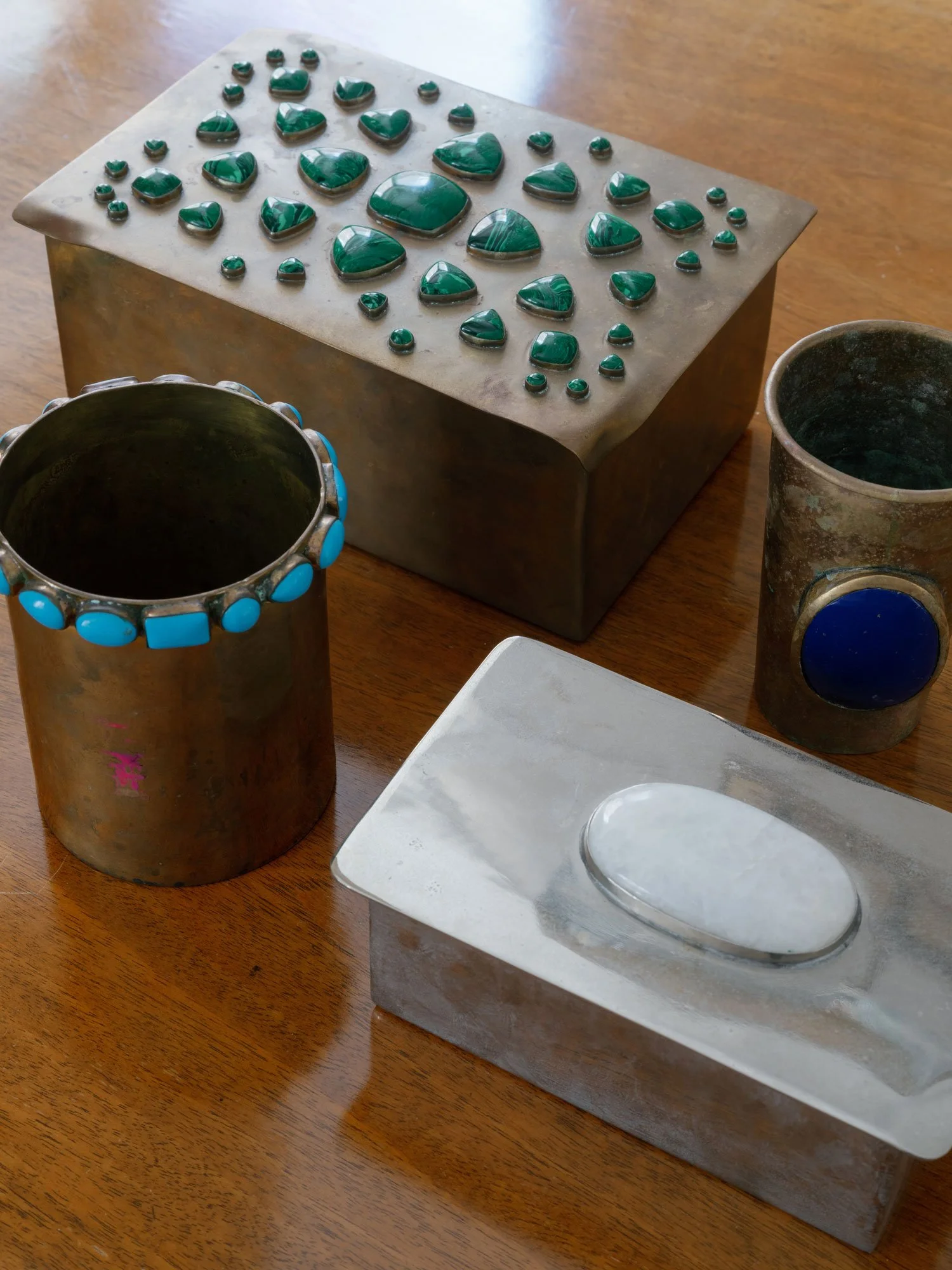 New York City interior design detail by Elizabeth Hartz Interior Design featuring curated brass accessories, decorative boxes with stone inlays, and sculptural tabletop styling.