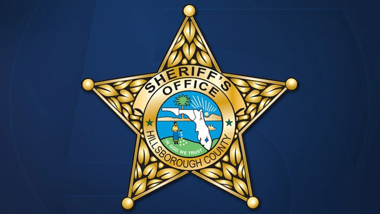 Hillsborough County Sheriff's Office badge featuring a star with a circular emblem in the center that shows a tree, water, and a person fishing.