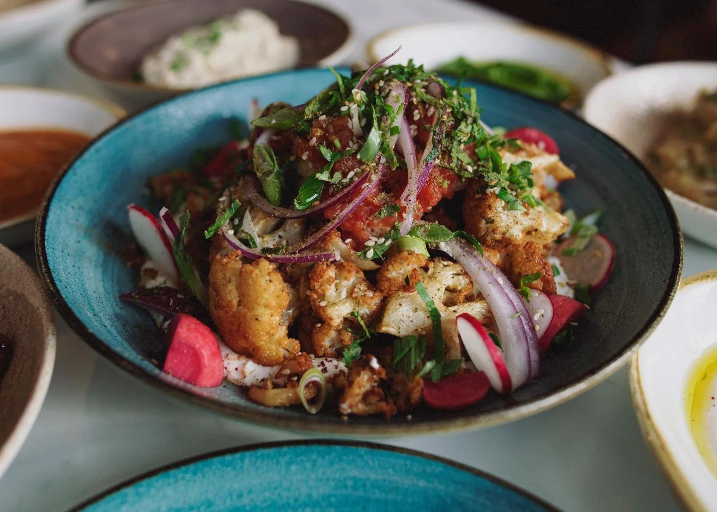 One of those dishes that makes everyone at the table shush; our fried cauliflower. A real explosion of textures and flavours, featuring a sensationally seasoned, fried, cauliflower nestled atop a bed of tangy, rich, labneh, and topped with an array o