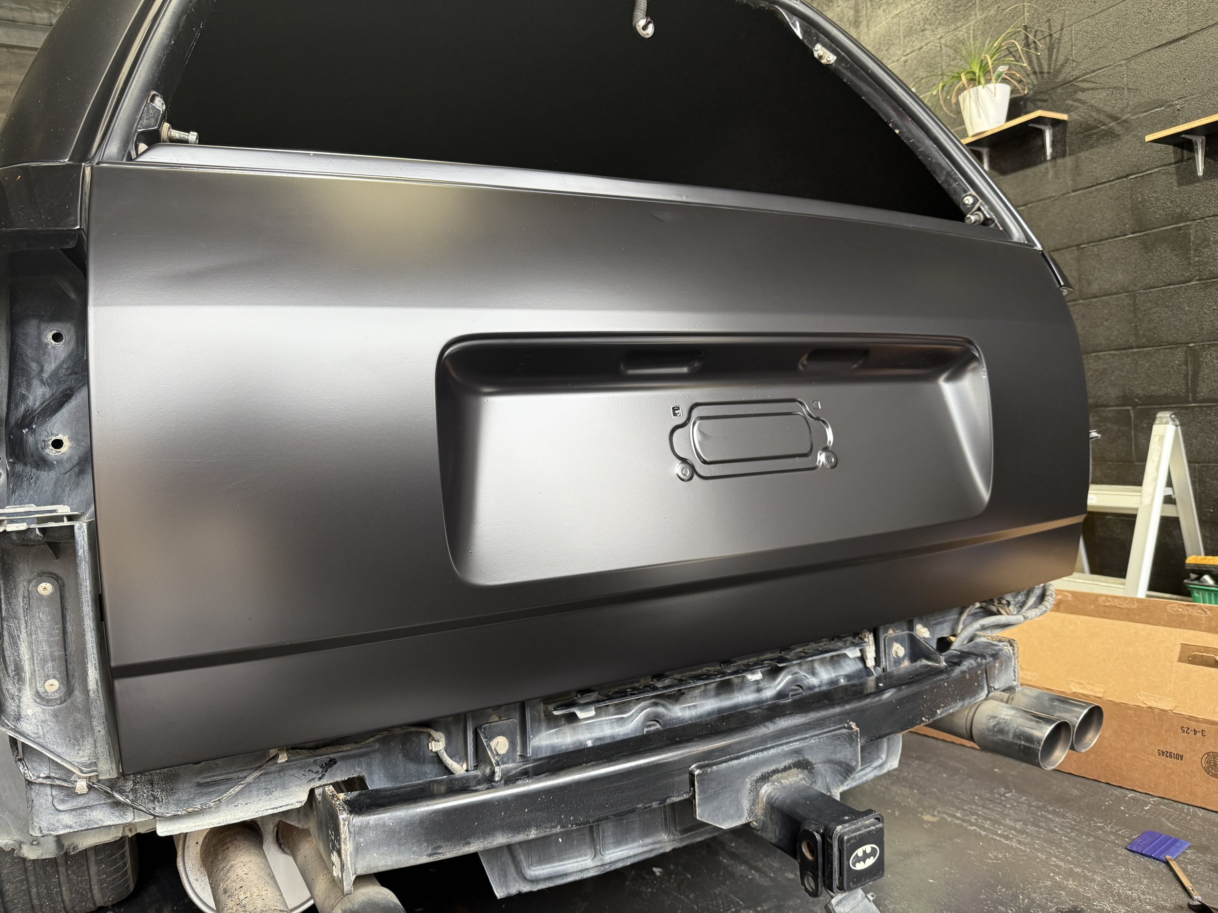 Finished wrapping car in Satin Obsidian Black Supreme Wrapping Film by Avery Dennison.