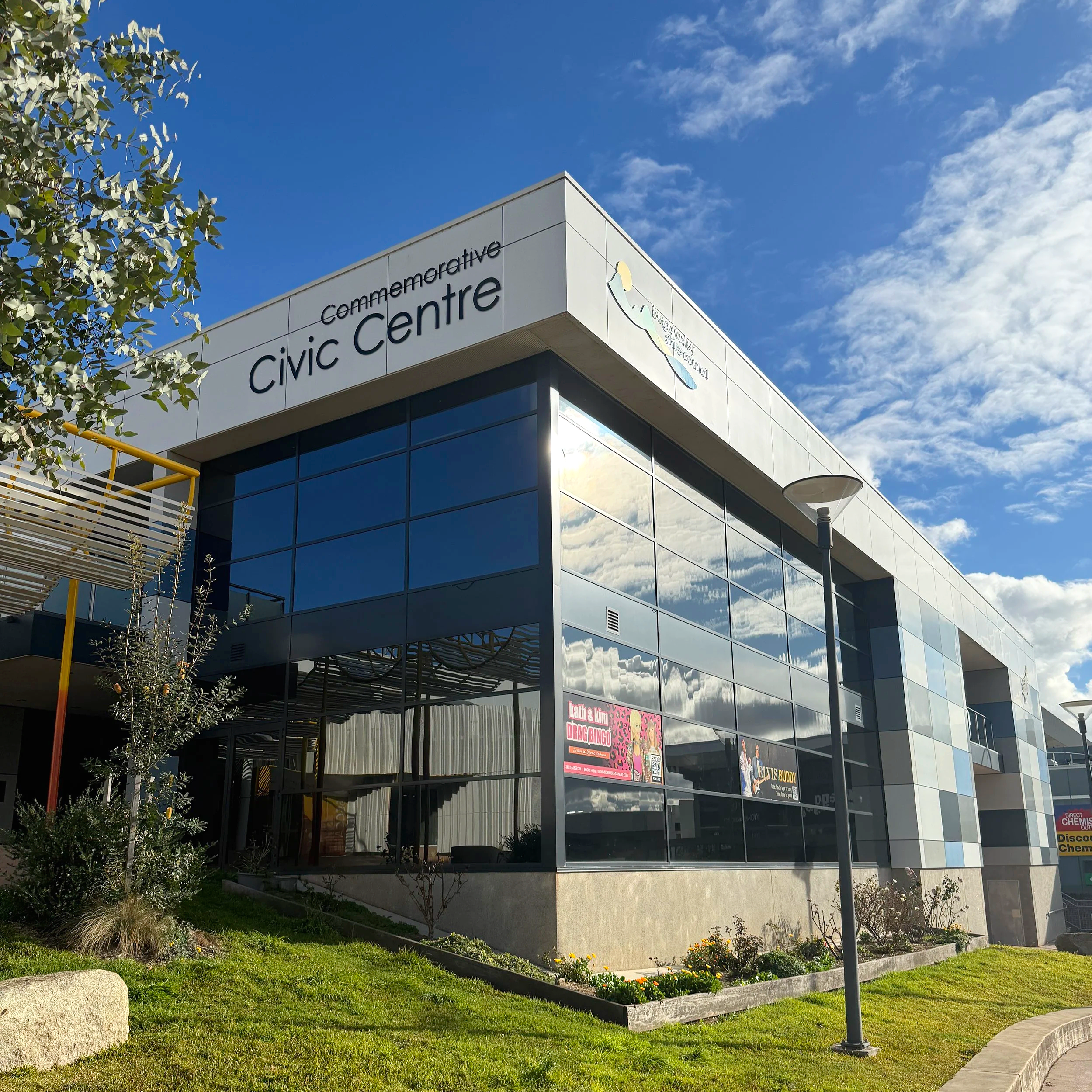 Exterior view of the Bega Valley Shire Commemorative Civic Centre building with large tinted windows.