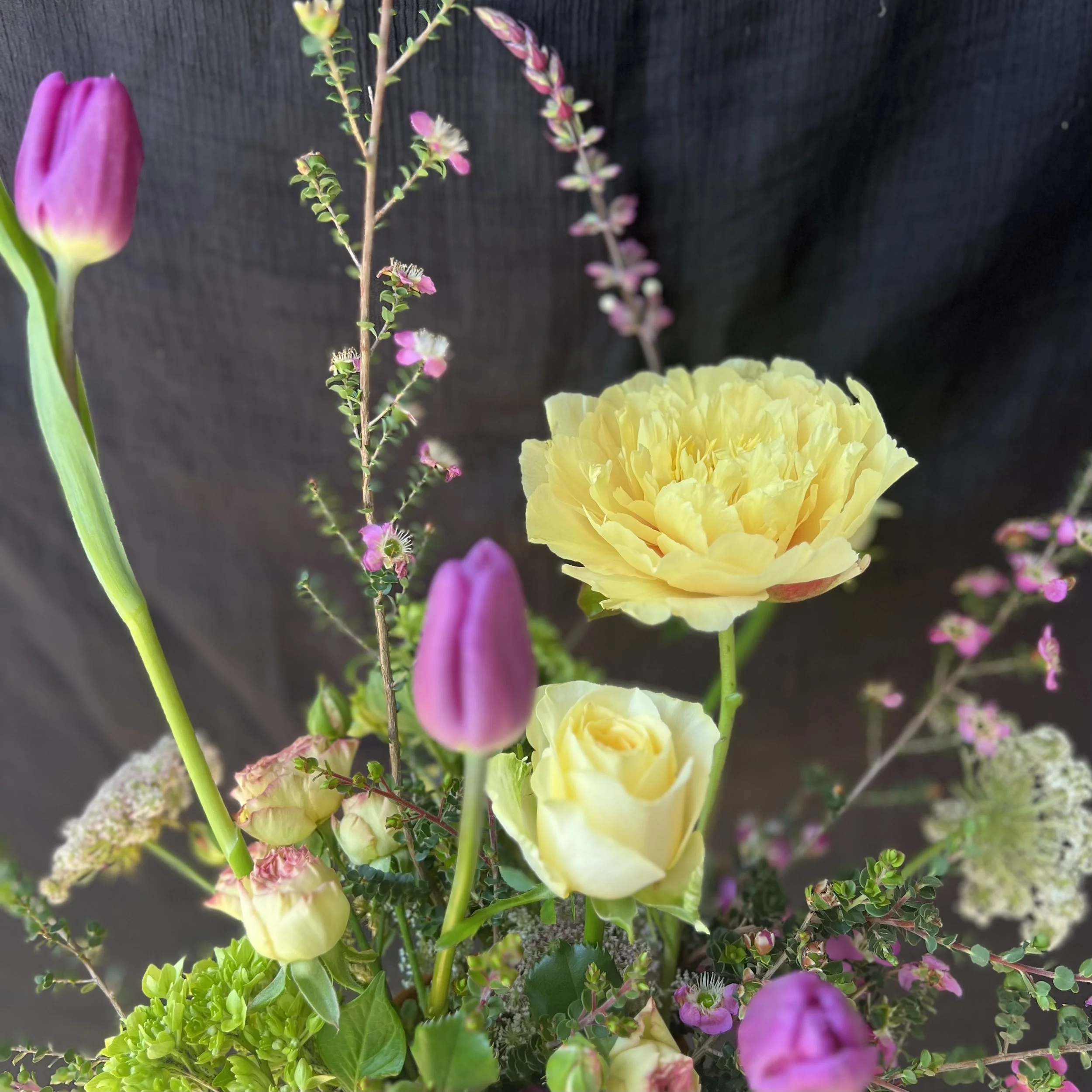 Cheerful Mother’s Day bouquet in purple and sunny yellow tones with fresh seasonal blooms