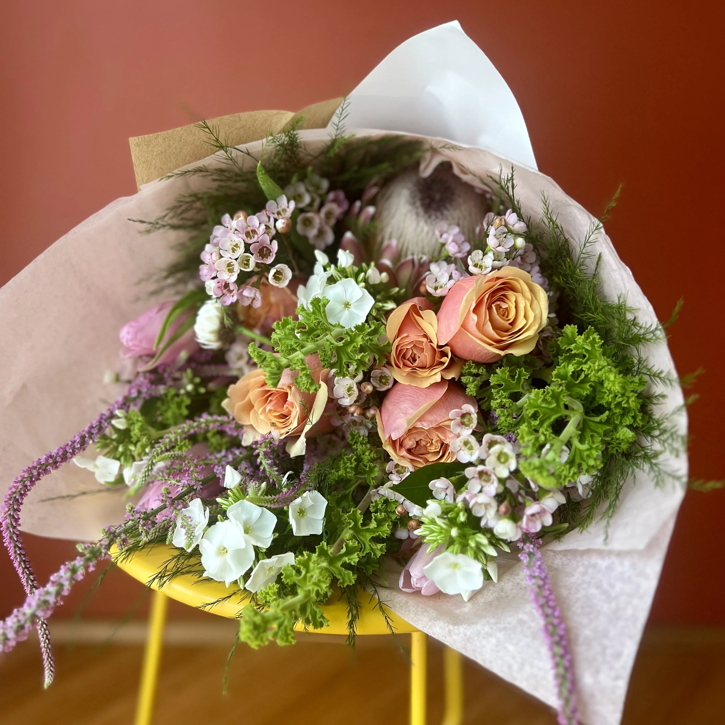 Romantic hand-tied bouquet featuring roses and tulips from a local florist in Berkeley, CA.