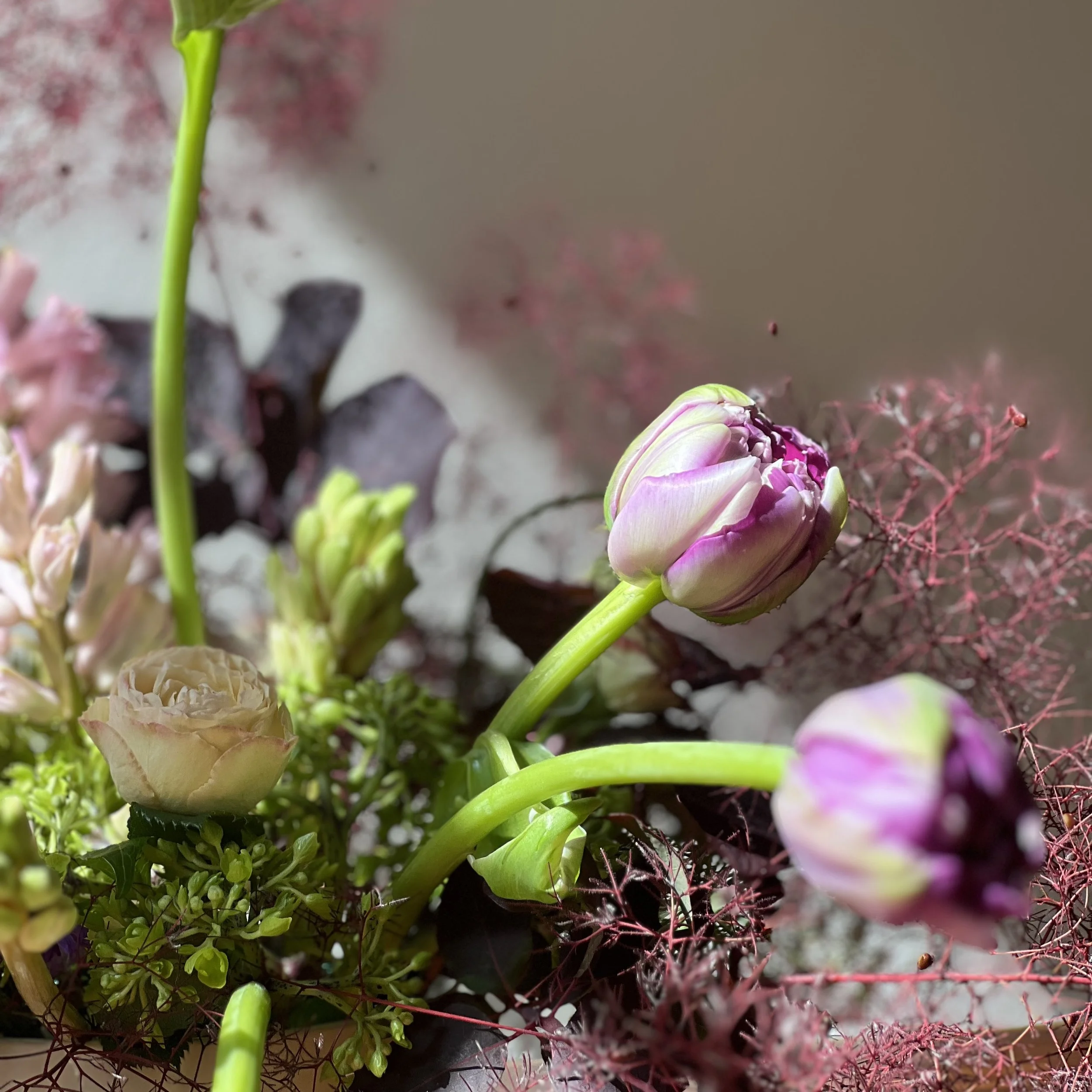 Textural detail of seasonal flowers in a loose, organic bouquet with natural movement.