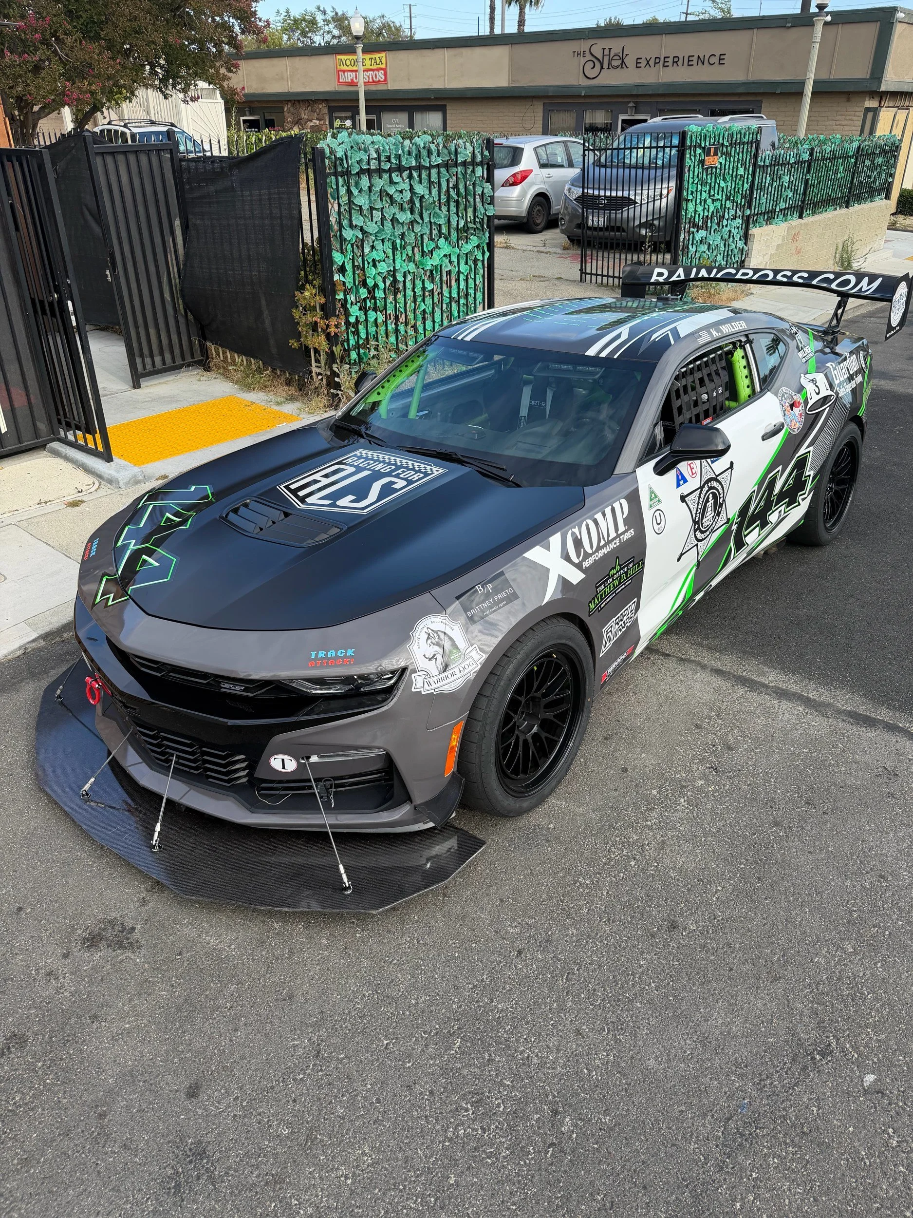 Custom carbon fiber front splitter on #144 Camaro, front three-quarter view