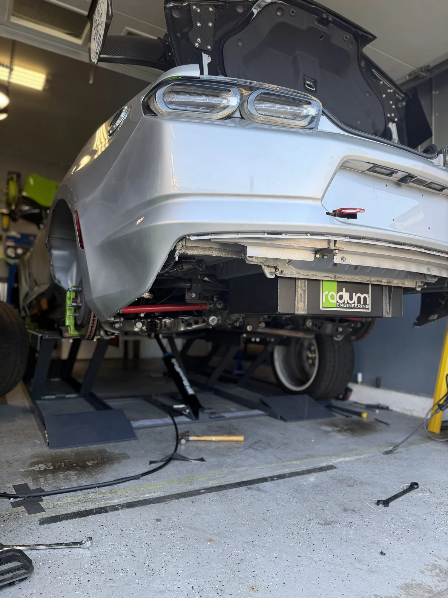 Wilder Racing #144 Camaro on a lift in Kyle Wilder's home garage