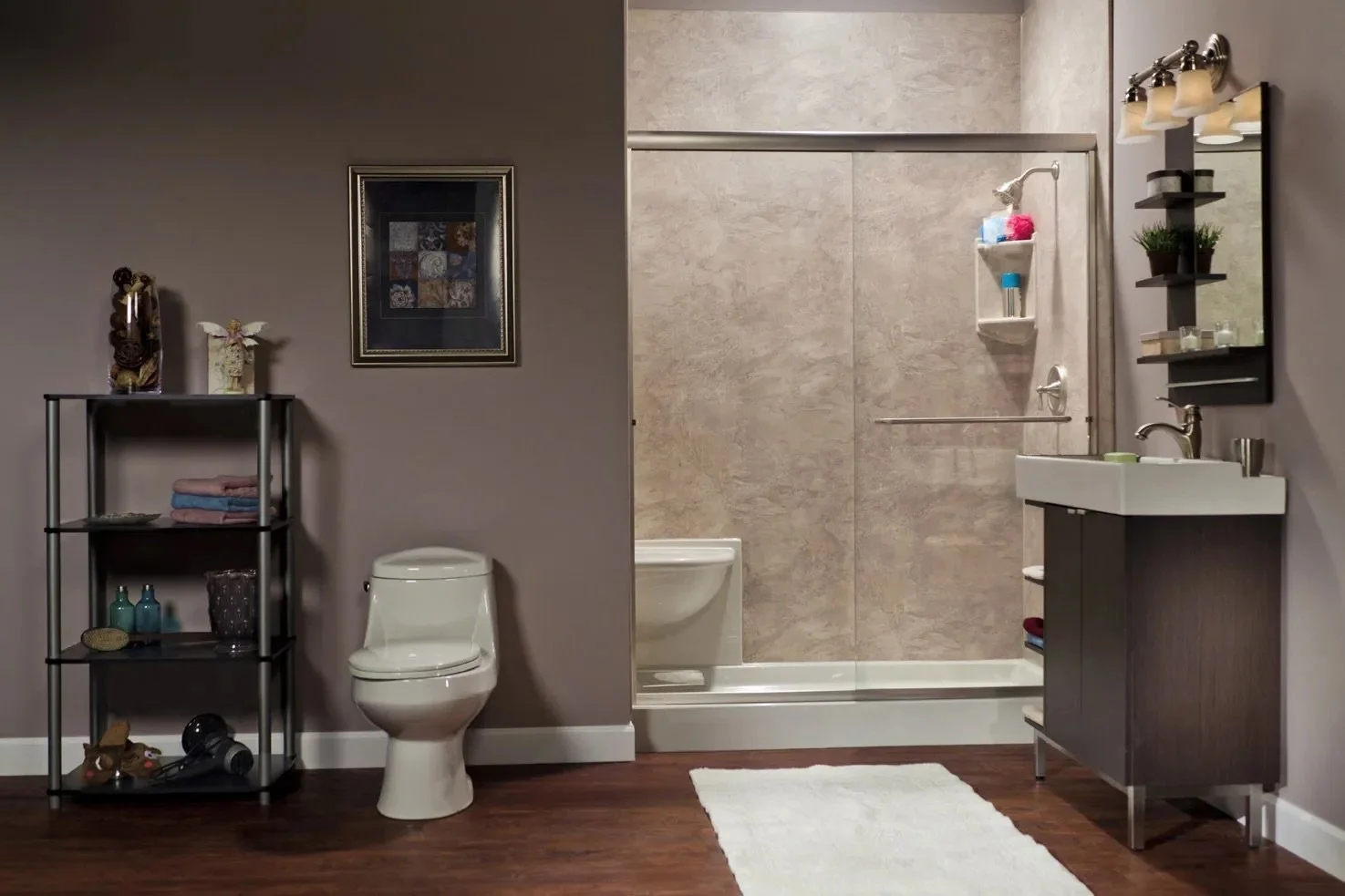 Bathroom with toilet, shower, sink, mirror, shelves, and decorative items