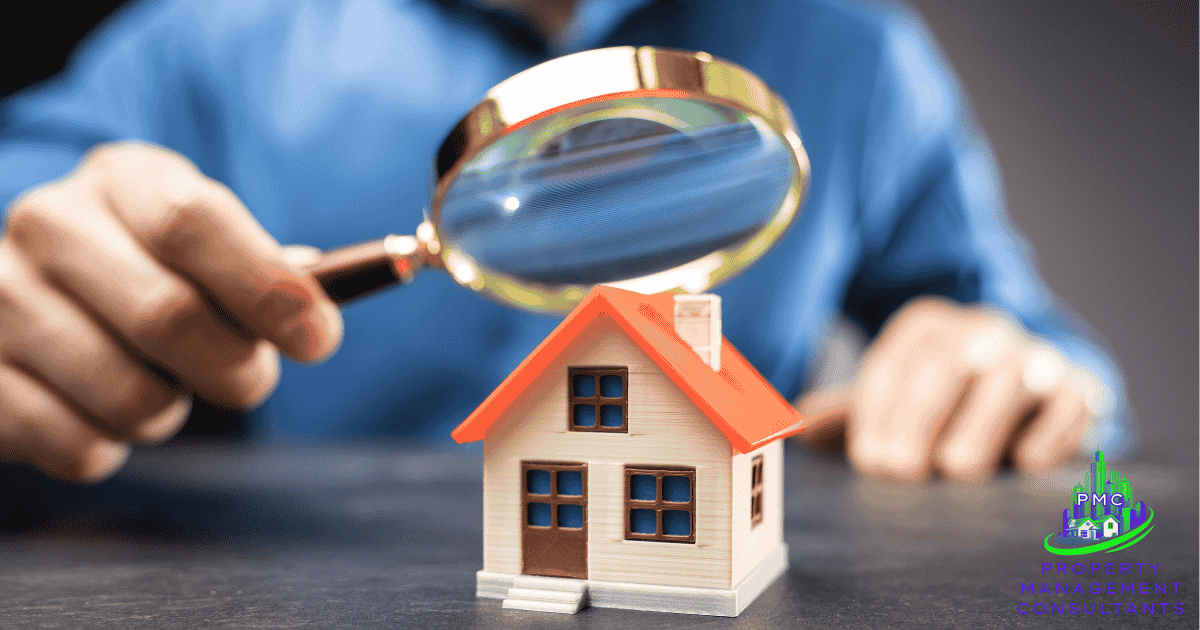 magnifying glass above a small model home indicating the attention to detail that property management consultants will provide to you