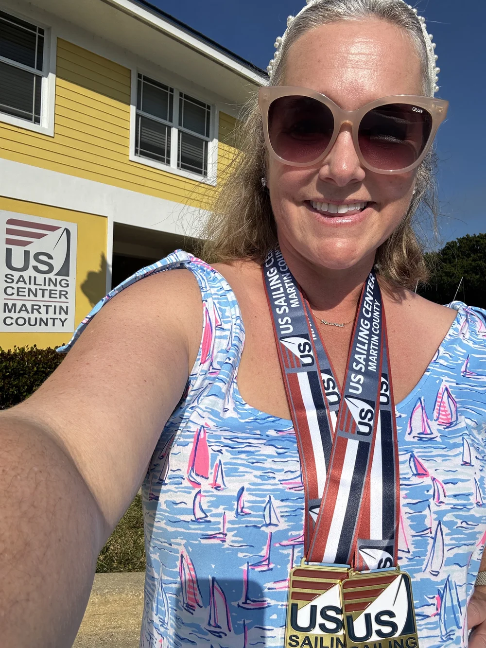 Lauren Wilson sports two medals for First Female and First place Apprentice at Masters Midwinters East at the US Sailing Center in Jensen Beach FL