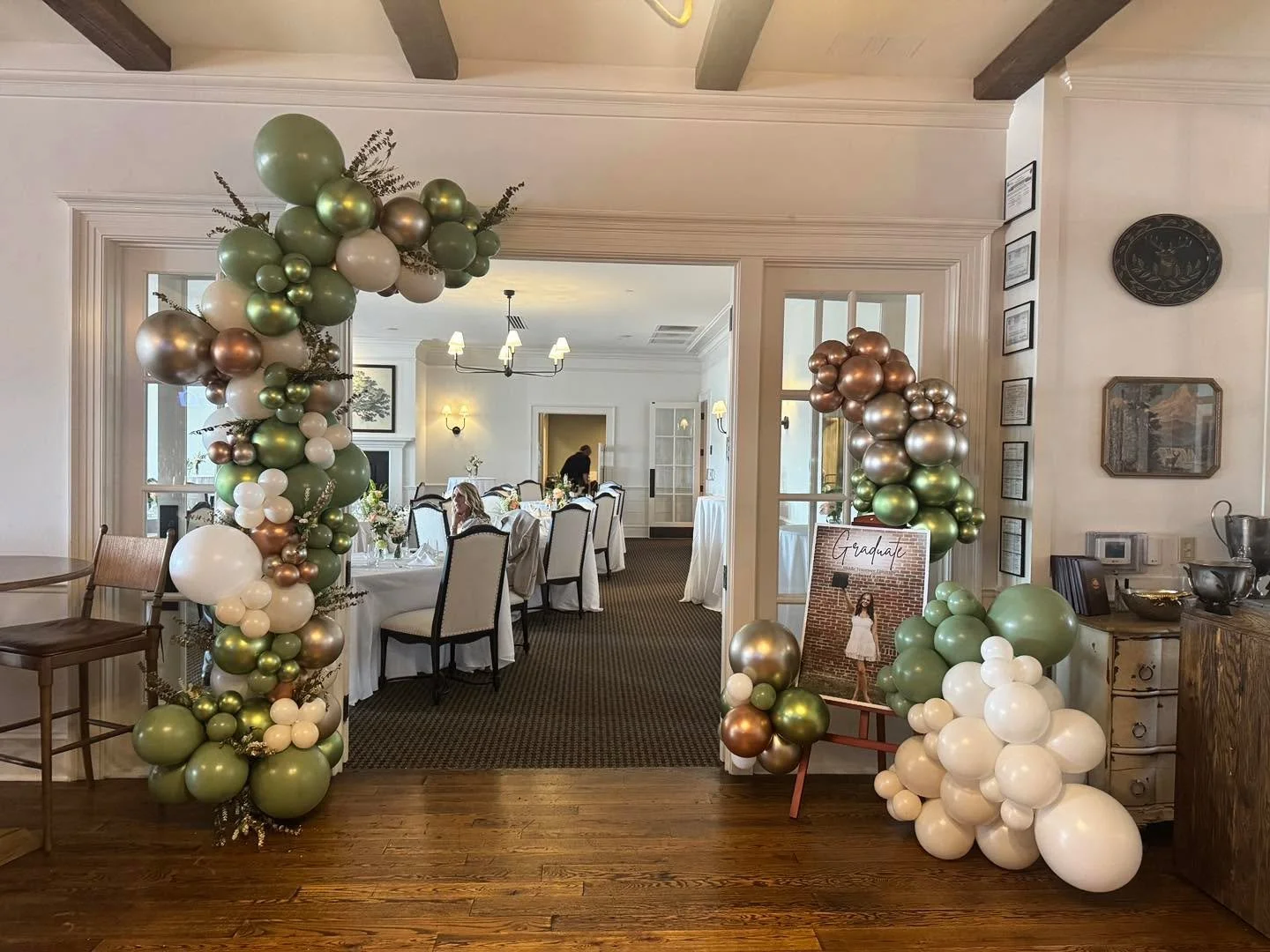 Graduation Party!! Eucalyptus green, white sand, white, gold, champagne, and metallic green balloons. Finished with groups of gold leaf eucalyptus and white flowers. Such a pretty color combo to compliment a pretty special graduate!! 
#murfreesboro #
