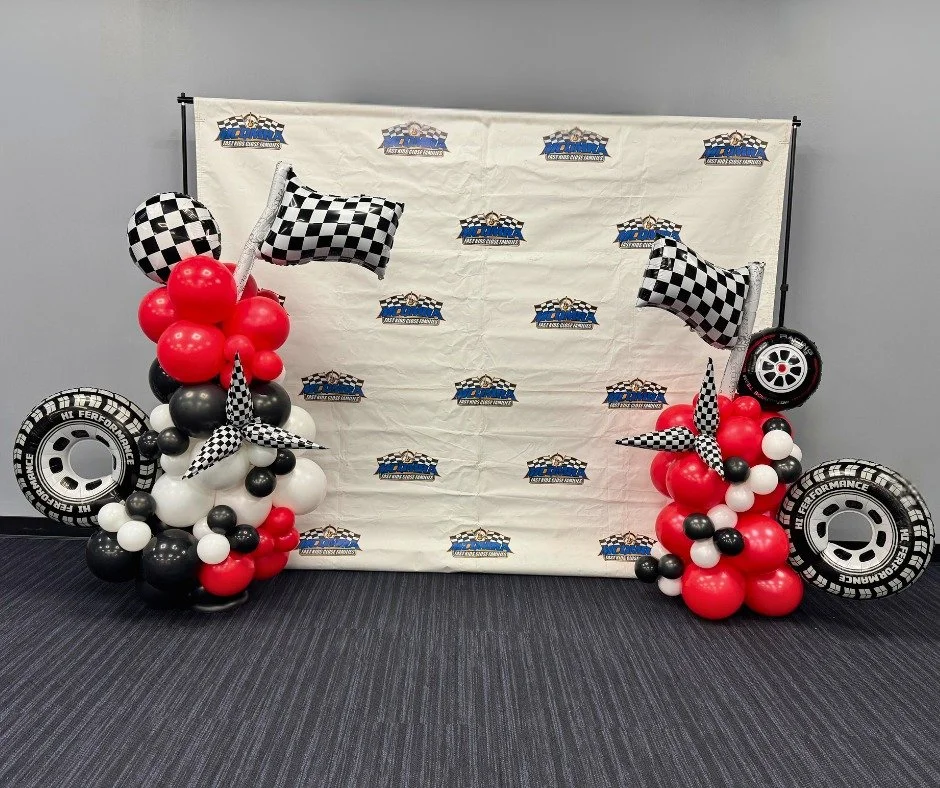 Banquet balloons for the Music City Quarter Midget Racing Association.  My all-time favorite color combination. The checkered balloons looked so good next to the red and the tires fit the occasion perfectly! Pictures do not show it, but the solid col