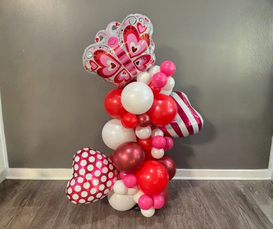 Valentine Balloon decor for the Learning Zone and a giant heart for Pastries with Parents backdrop at school. The heart was the first one I had attempted. 144 balloons strung together and shaped into a heart (which got a little squishy with travel).
