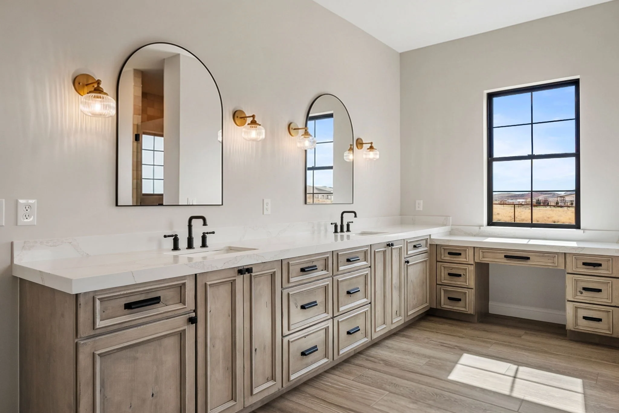 This custom vanity showcases Shiloh Custom Cabinetry crafted from knotty, high-character alder and finished in the popular “White Sands” stain. Accented with bold black hardware from Top Knobs, this design delivers a warm, rustic-modern aesthetic wit