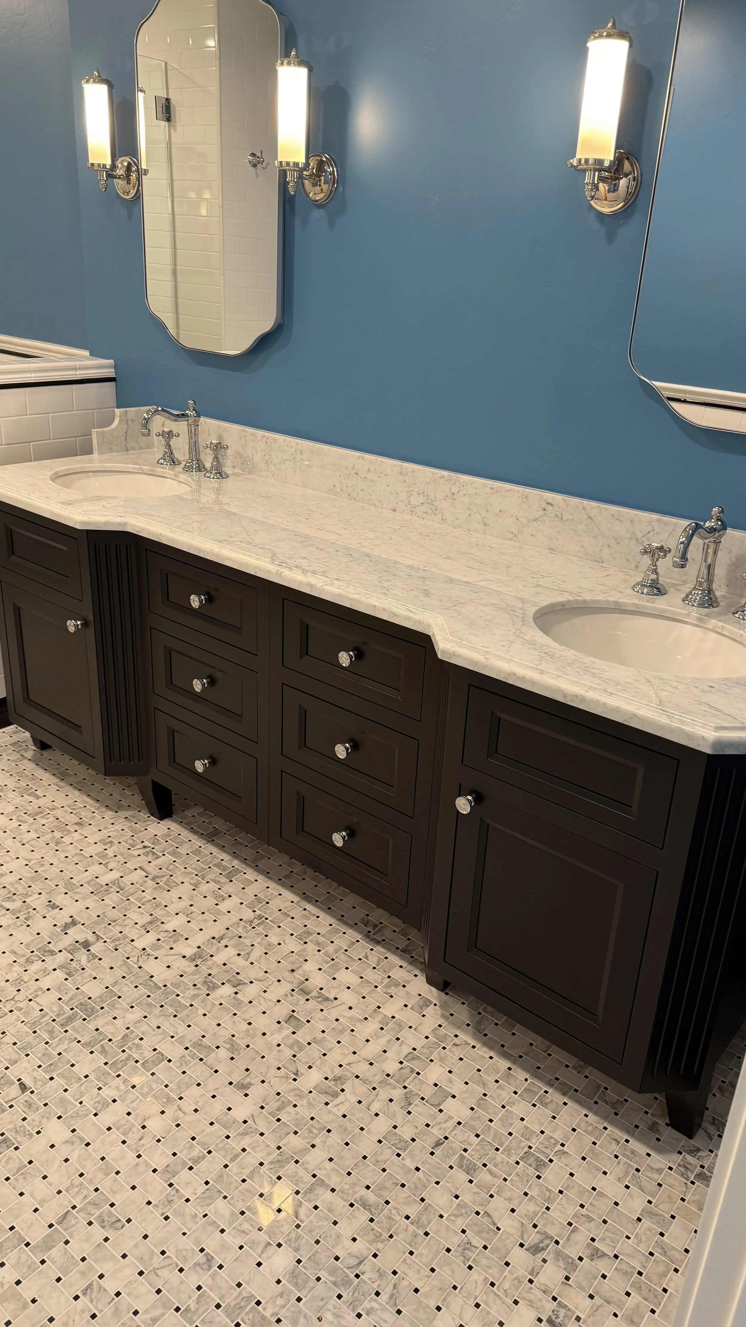 custom vanity cabinet featuring clipped fluted corners and top knobs hardware, made to look like furniture