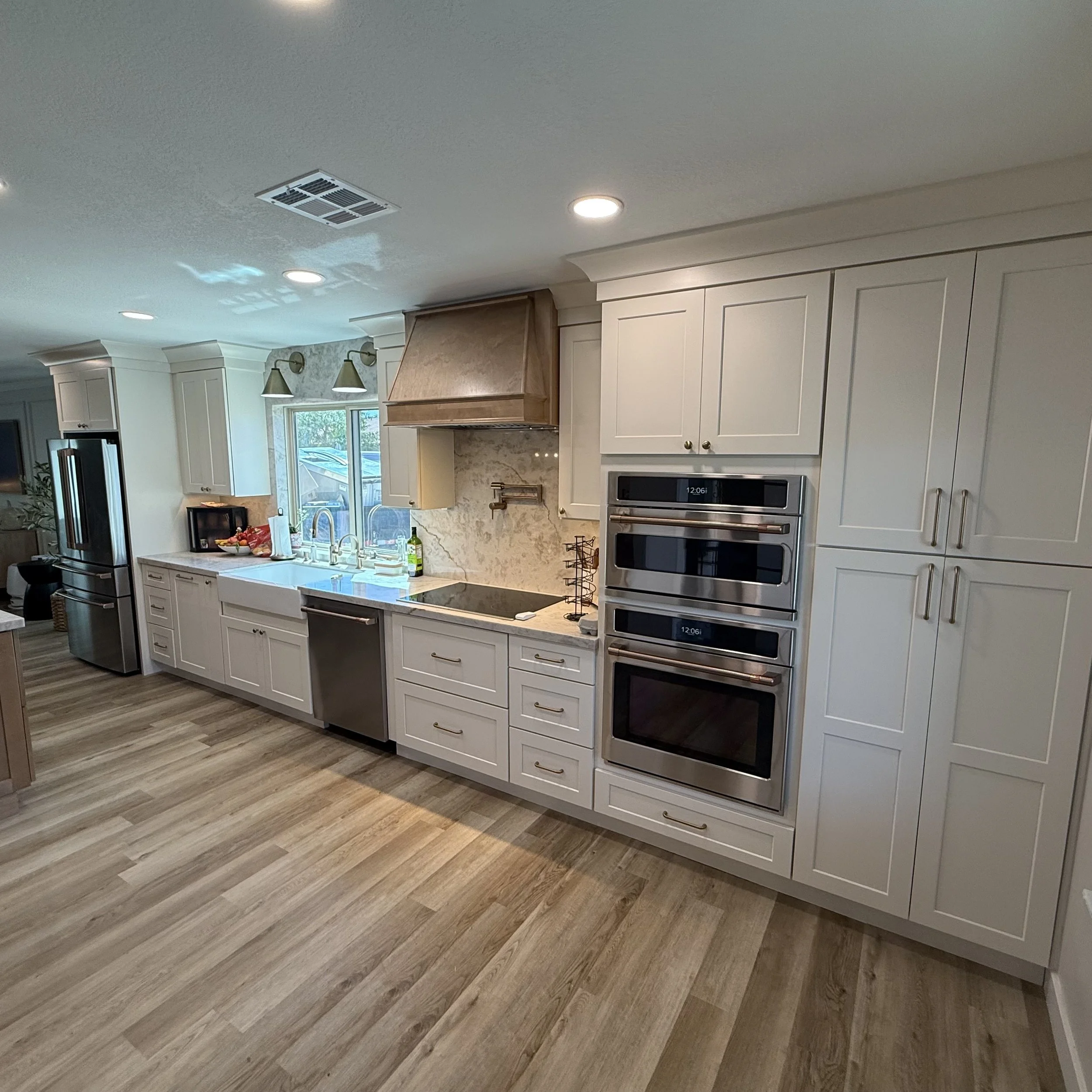 Antique white shaker cabinetry with quartz backsplash