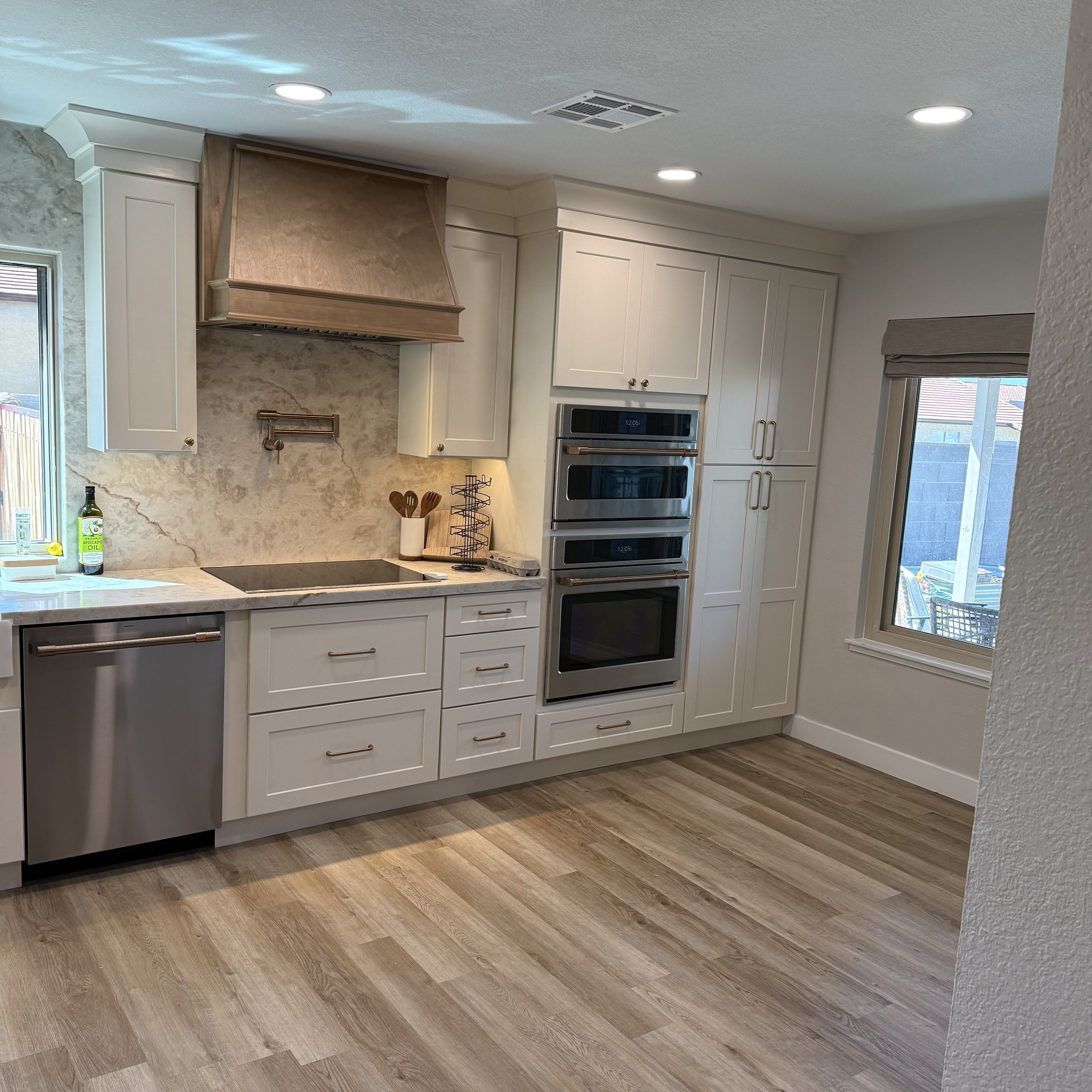 Antique white shaker cabinetry with quartz backsplash
