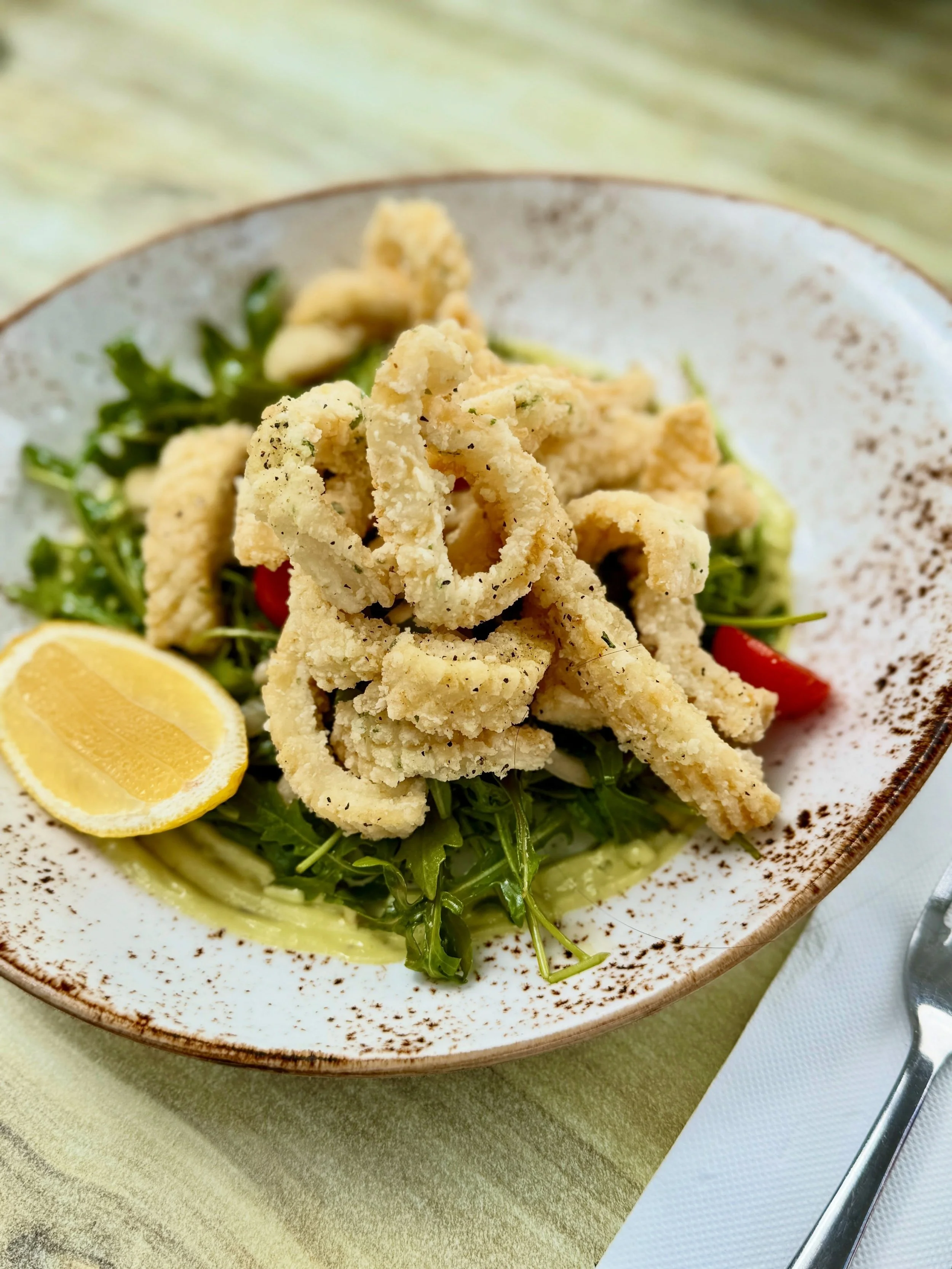 Our Lemon &amp; Pepper Crispy Calamari is a favourite of locals for good reason.

Served with rocket, cos lettuce, cherry tomatoes, pickled fennel, cucumber, lemon dressing and basil aioli, it&rsquo;s light yet somehow still a little indulgent, and p