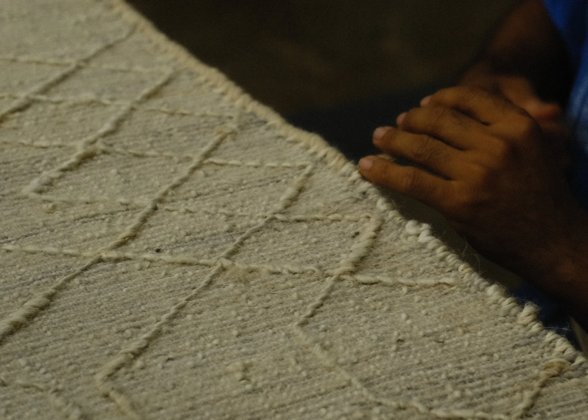 Hand serging on a woven hand-made rug.