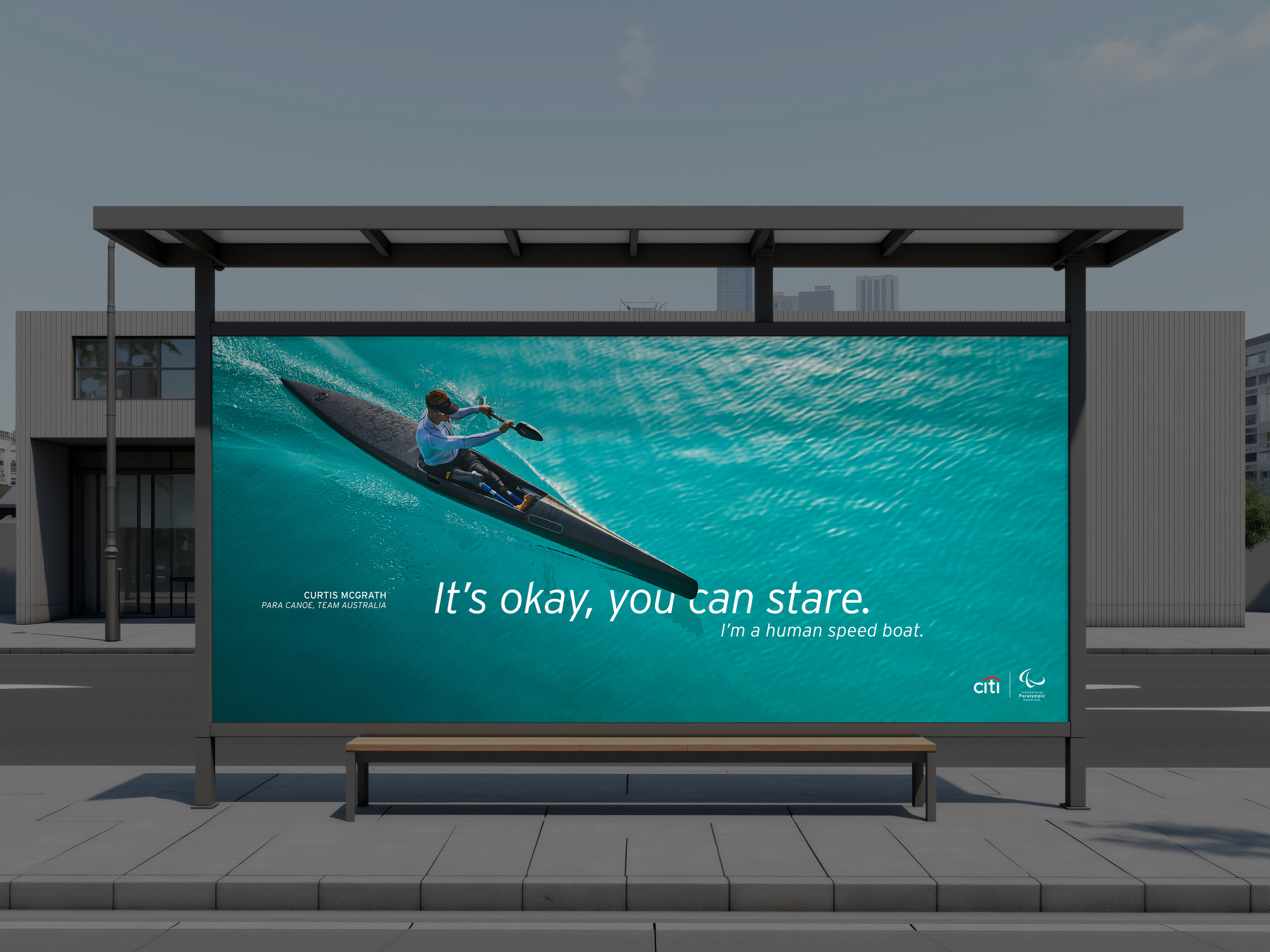 Billboard with an image of a person speed kayaking on turquoise water, promoting human speed boating and endurance, with text that says 'It’s okay, you can stare. I’m a human speed boat,' and logos for Citi and Paralympic team.