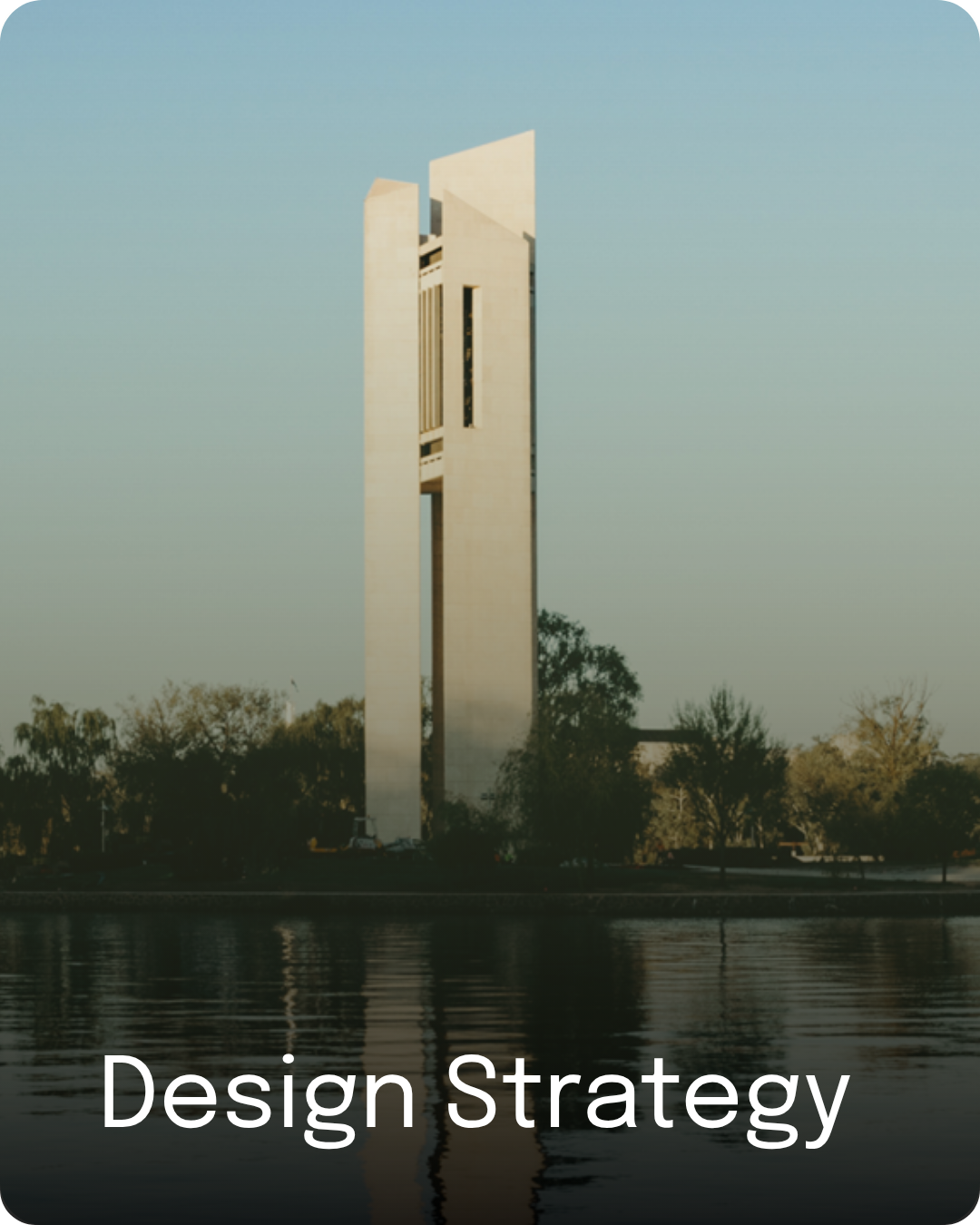 Carillon tower reflected on Lake Burley Griffin, representing design strategy.