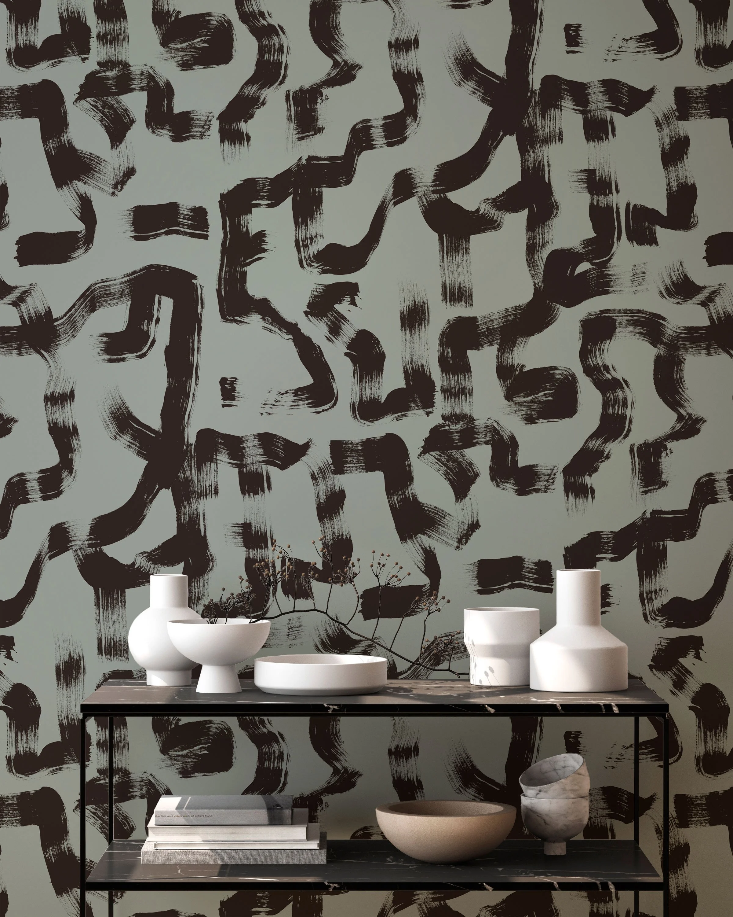 Sage green brushstroke wallpaper with sculptural white ceramics and modern black console table